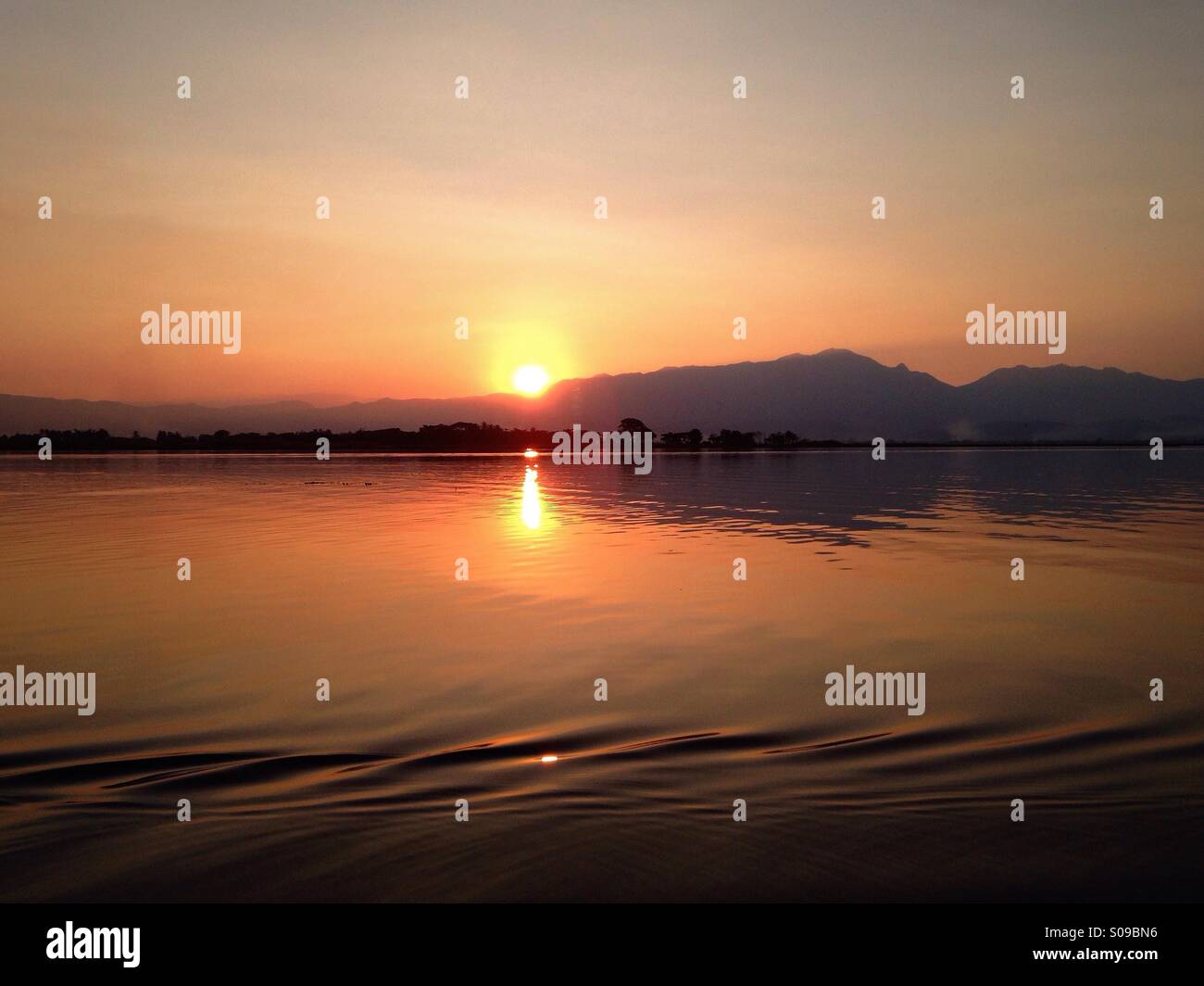 Stirring up ripples on the smooth surface of Kwan Phayao (Phayao Lake). Phayao, Thailand. Stock Photo