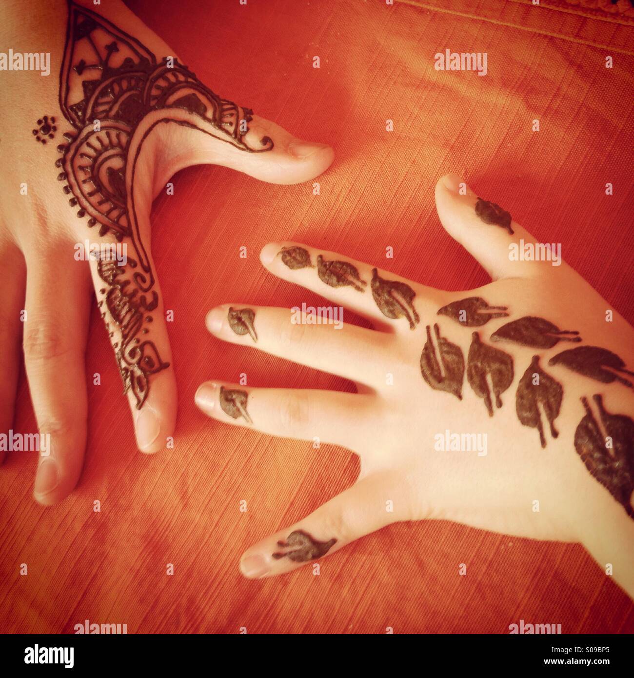 Child and mother's hands with henna paste on them. In Morocco. Stock Photo