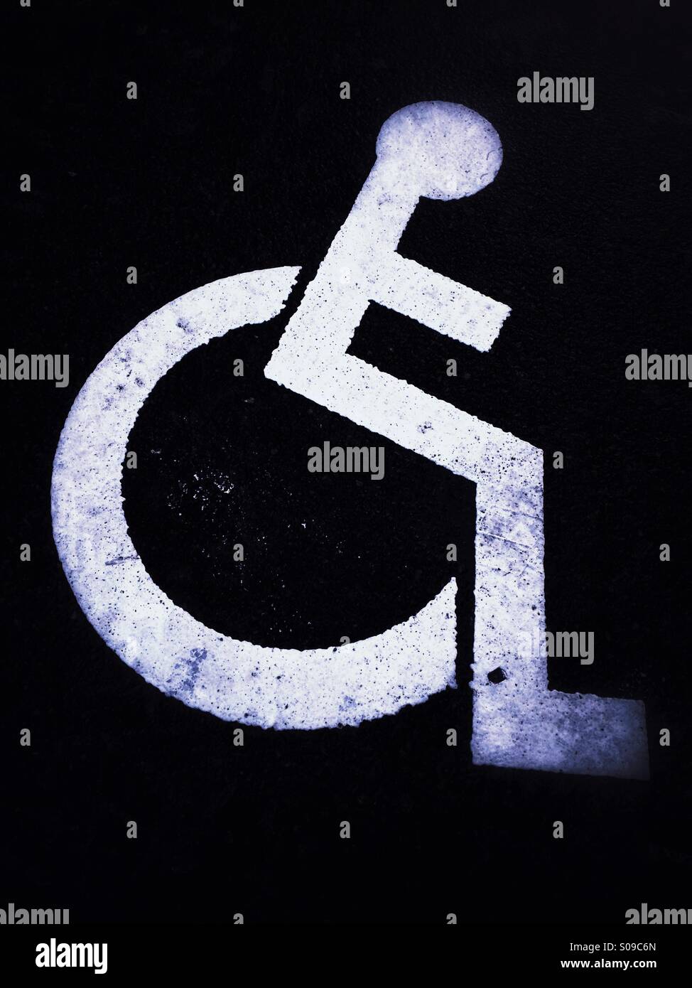 Handicapped / disabled parking sign painted on the road marking a