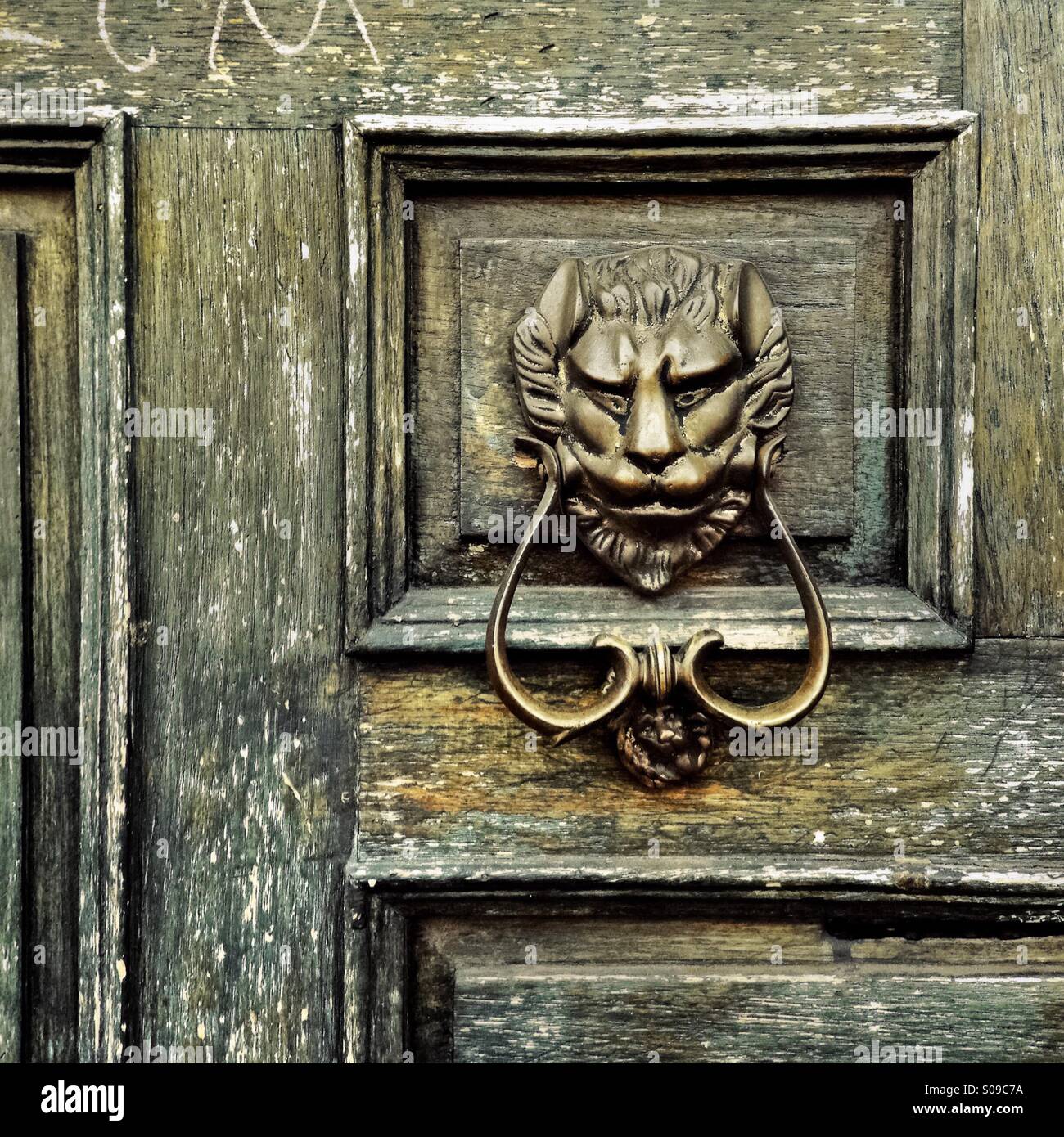 An antique door knocker is seen hung on the wooden door of a Spanish colonial house in Morelia, Mexico, 2 November 2014. Stock Photo