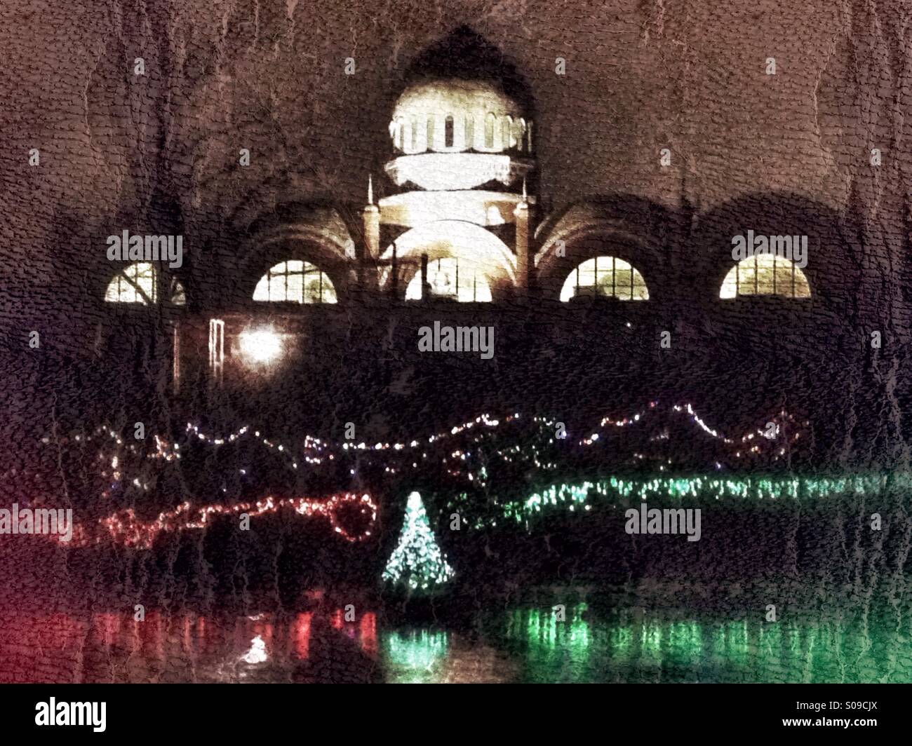 A Festival of Lights display on Swan Lake with the elephant house in the background. Stock Photo