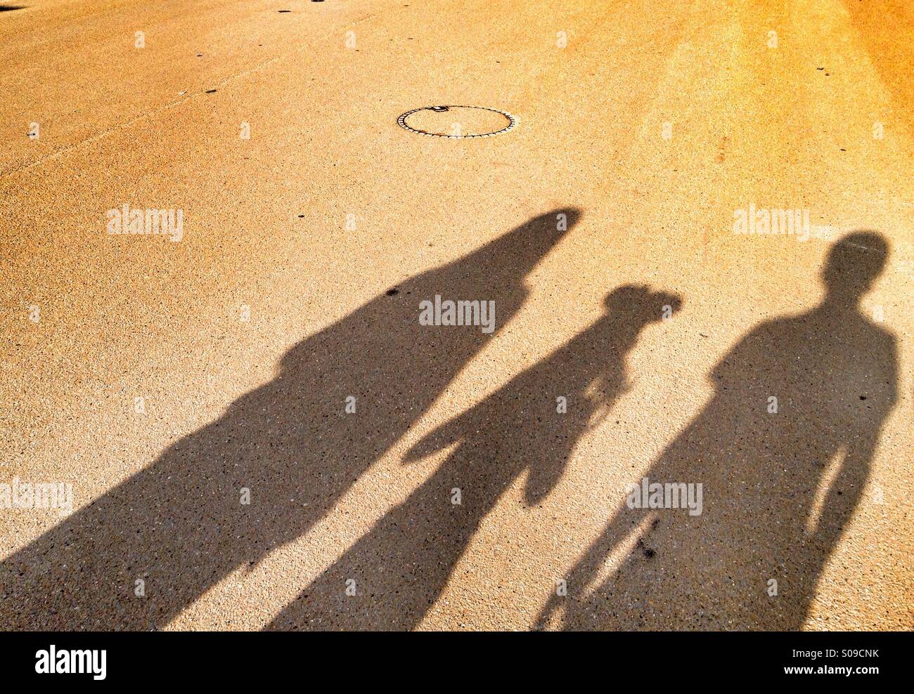 Three (3) person silhouette with one (1) child with mouse ears Stock Photo
