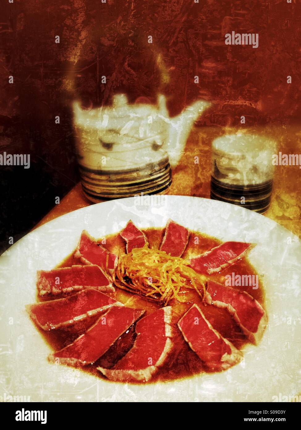 Grungy textured color photo of a tuna tataki with ponzu sauce appetizer and Japanese teapot and
