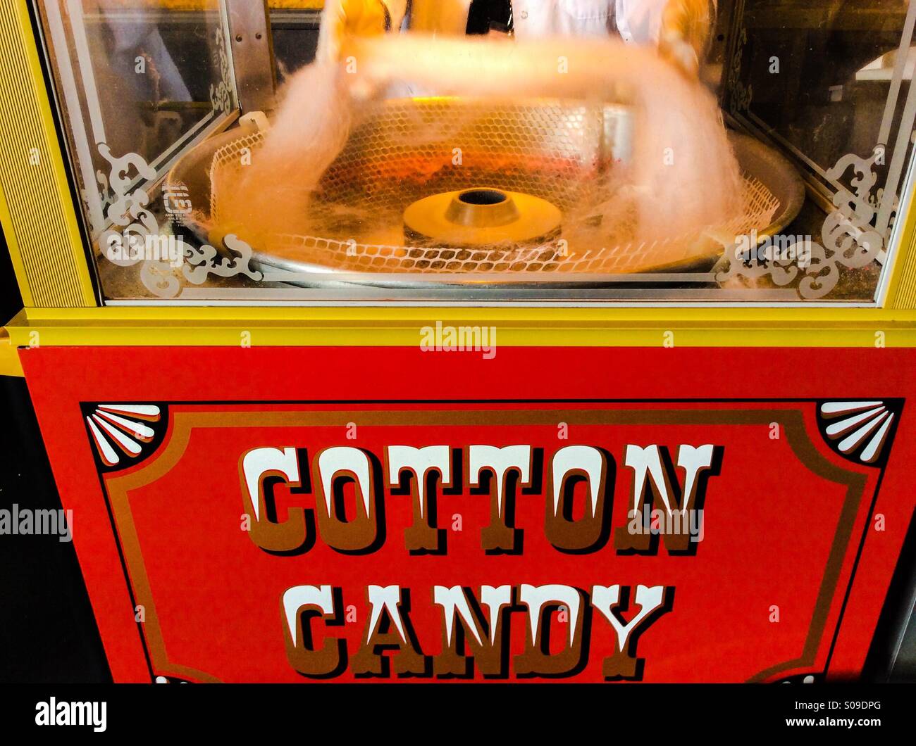 Cotton candy being freshly made in a cabinet with a glass enclosure, Ontario, Canada. A fixture and top attraction at fairs, circuses, and markets through the ages. A universal classic. Invented 1897. - Smartphone Captured Stock Image