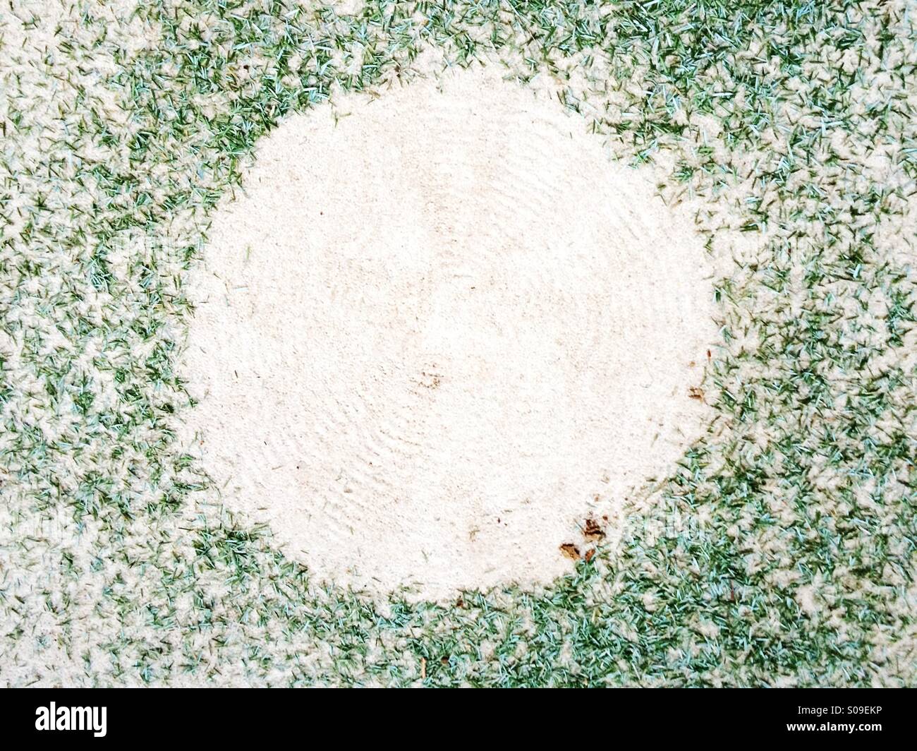 Christmas tree aftermath - fallen pine needles leave a circle of negative space after taking down the Christmas tree in January. Stock Photo