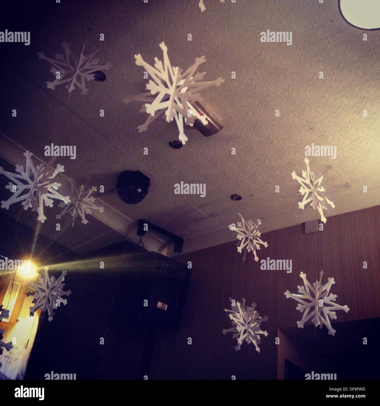 Festive snowflake decorations on bar ceiling. Stock Photo