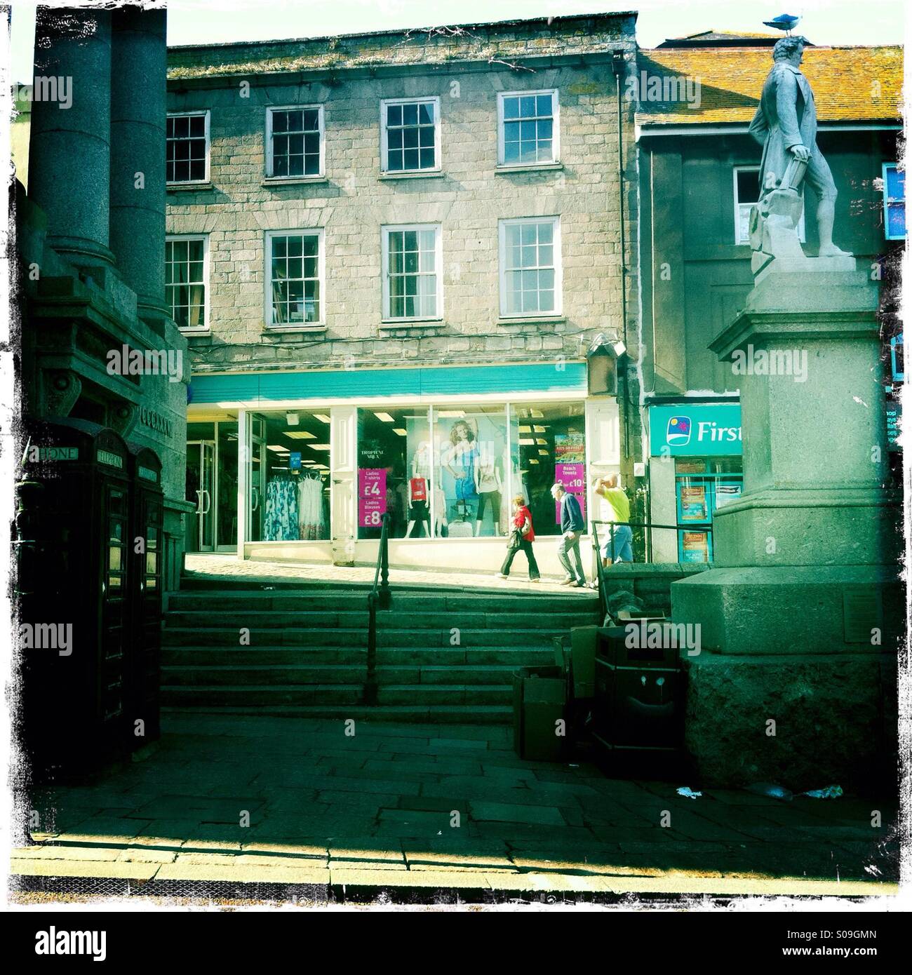 Shops and buildings behind statue of Humphry Davy in Penzance, Cornwall, UK. - Smartphone Captured Stock Image