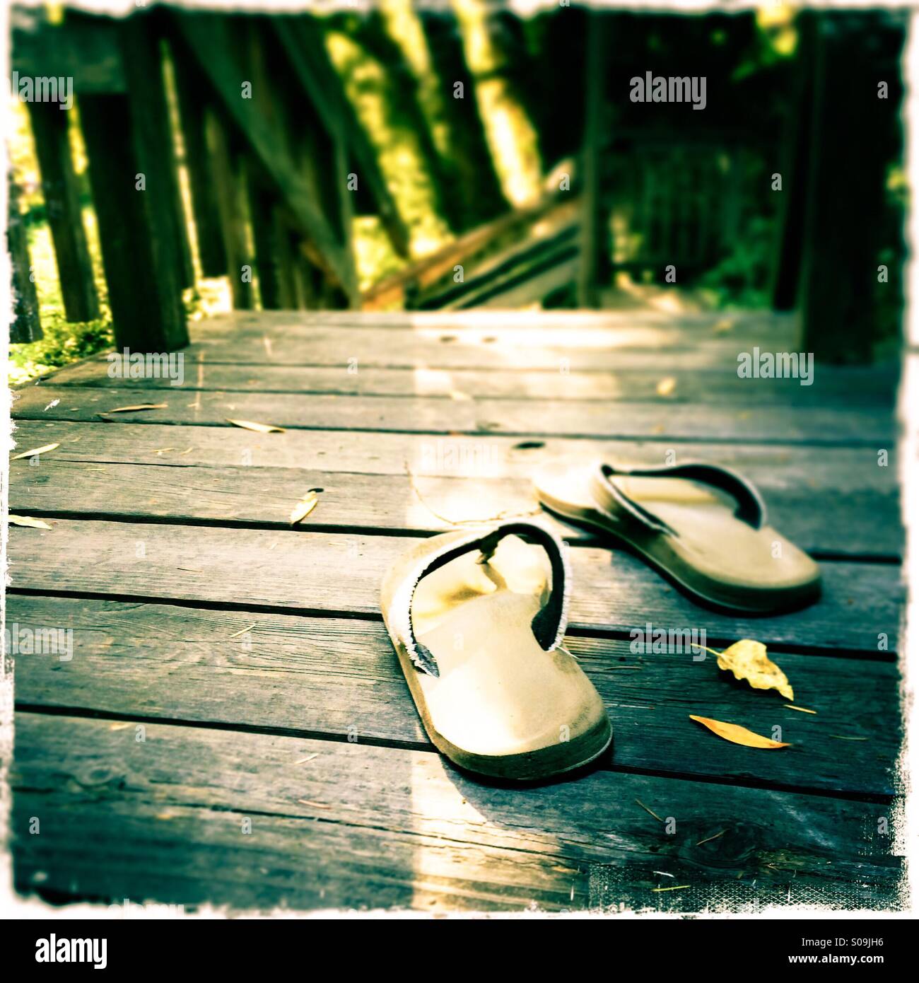 Sandals on a wooden deck. - Smartphone Captured Stock Image