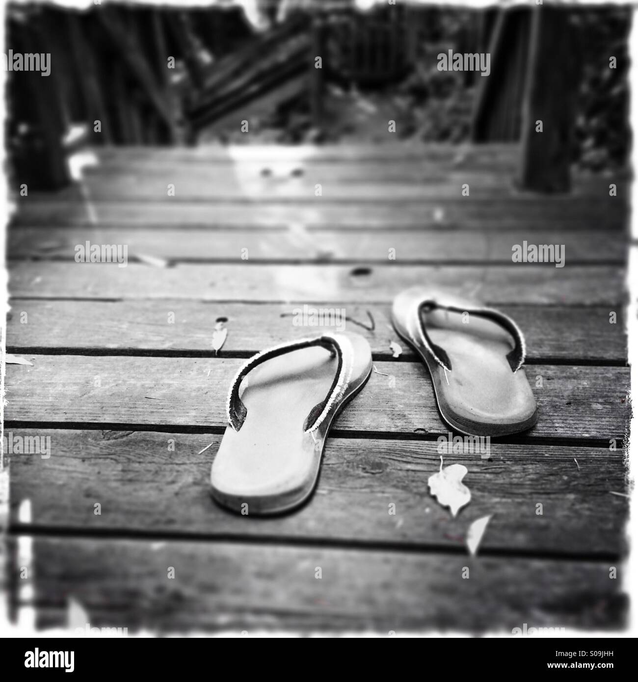 Sandals on a wooden deck. - Smartphone Captured Stock Image