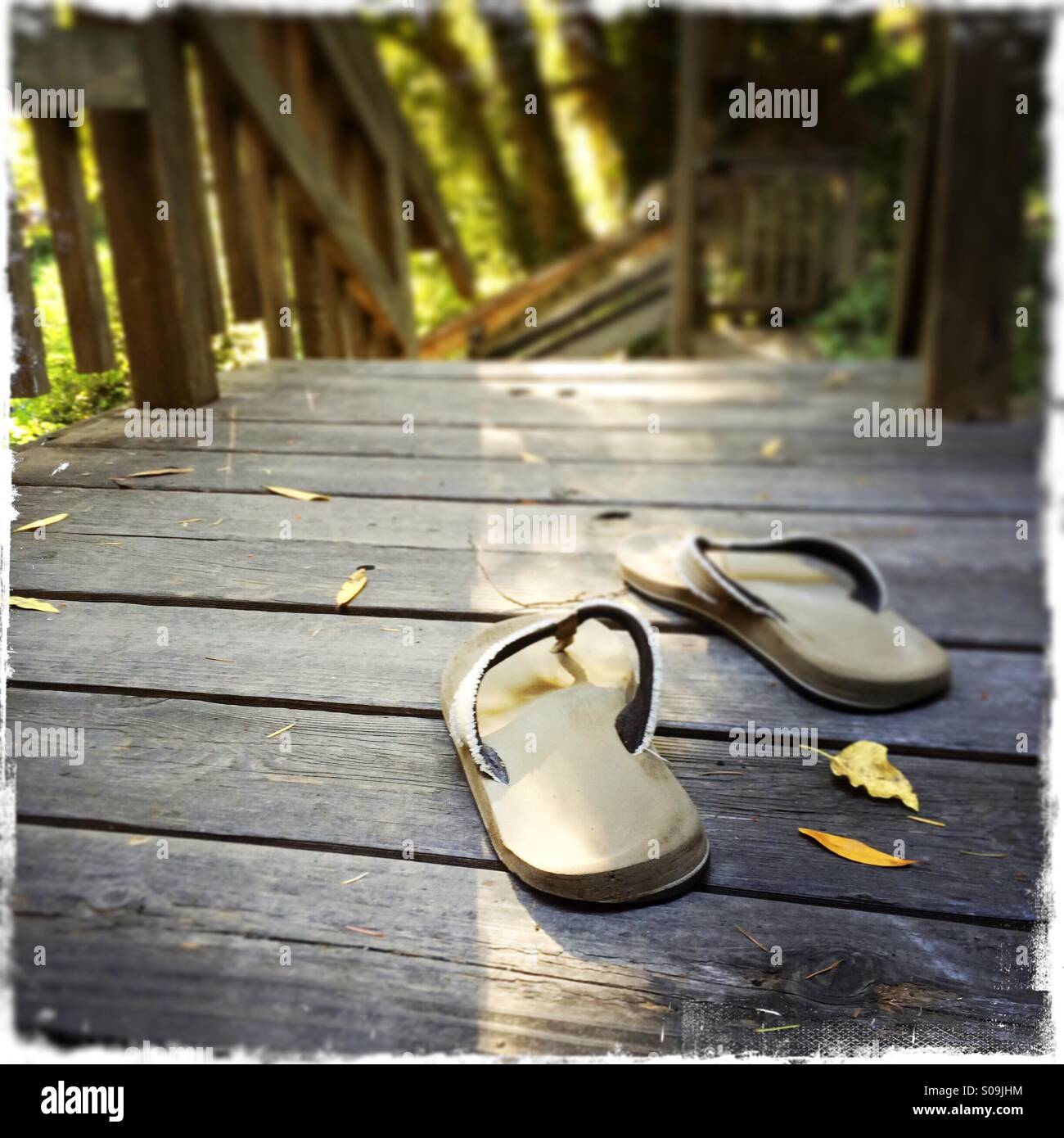 Sandals on a wooden deck. - Smartphone Captured Stock Image