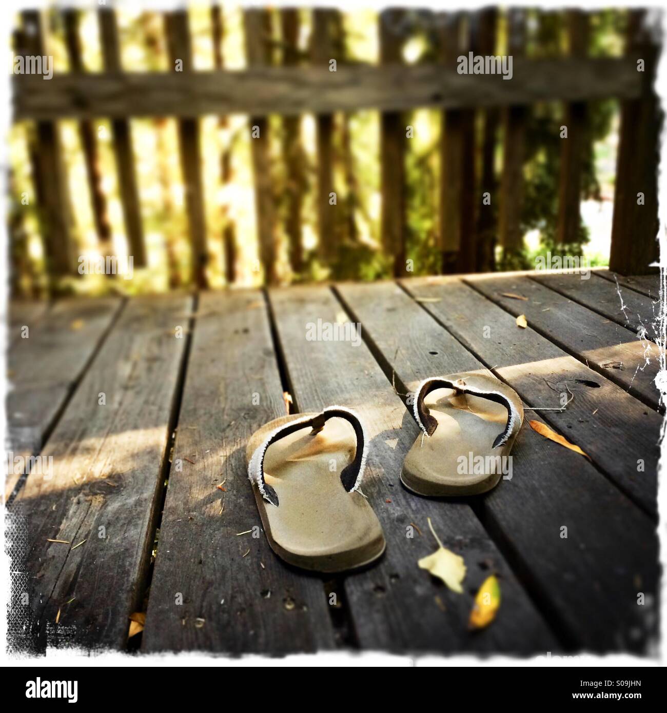 Sandals on a wooden deck. - Smartphone Captured Stock Image