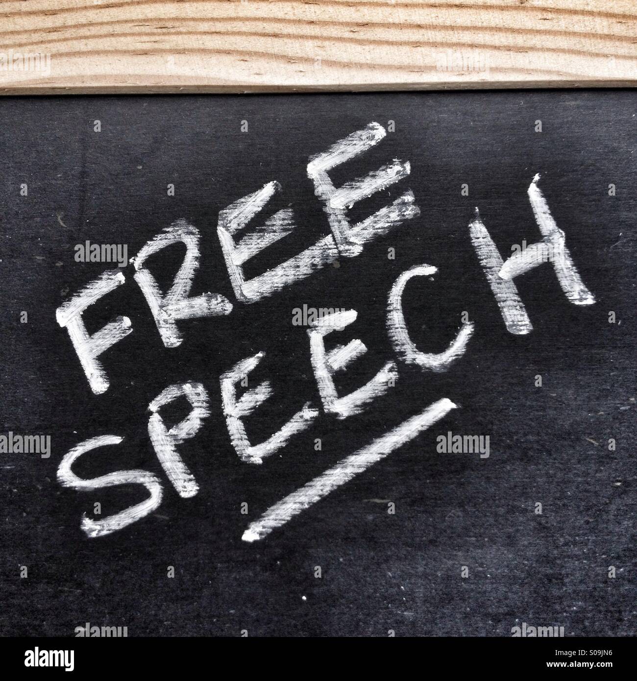 The phrase Free Speech written in white chalk on a blackboard Stock Photo