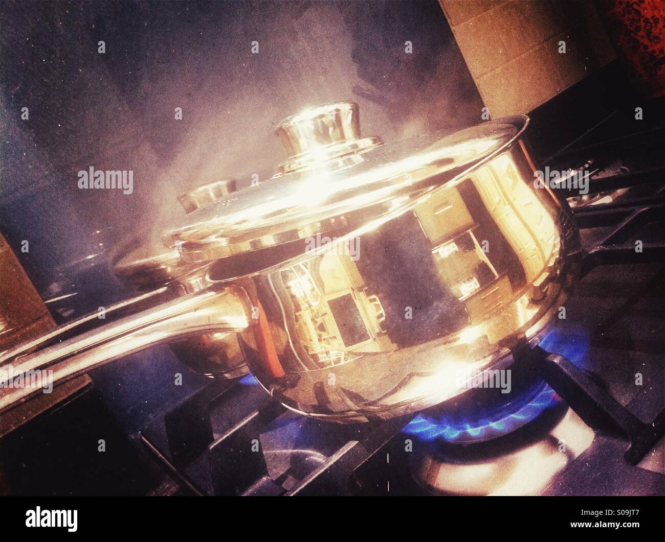 Stainless steel saucepans on gas hob Stock Photo Alamy