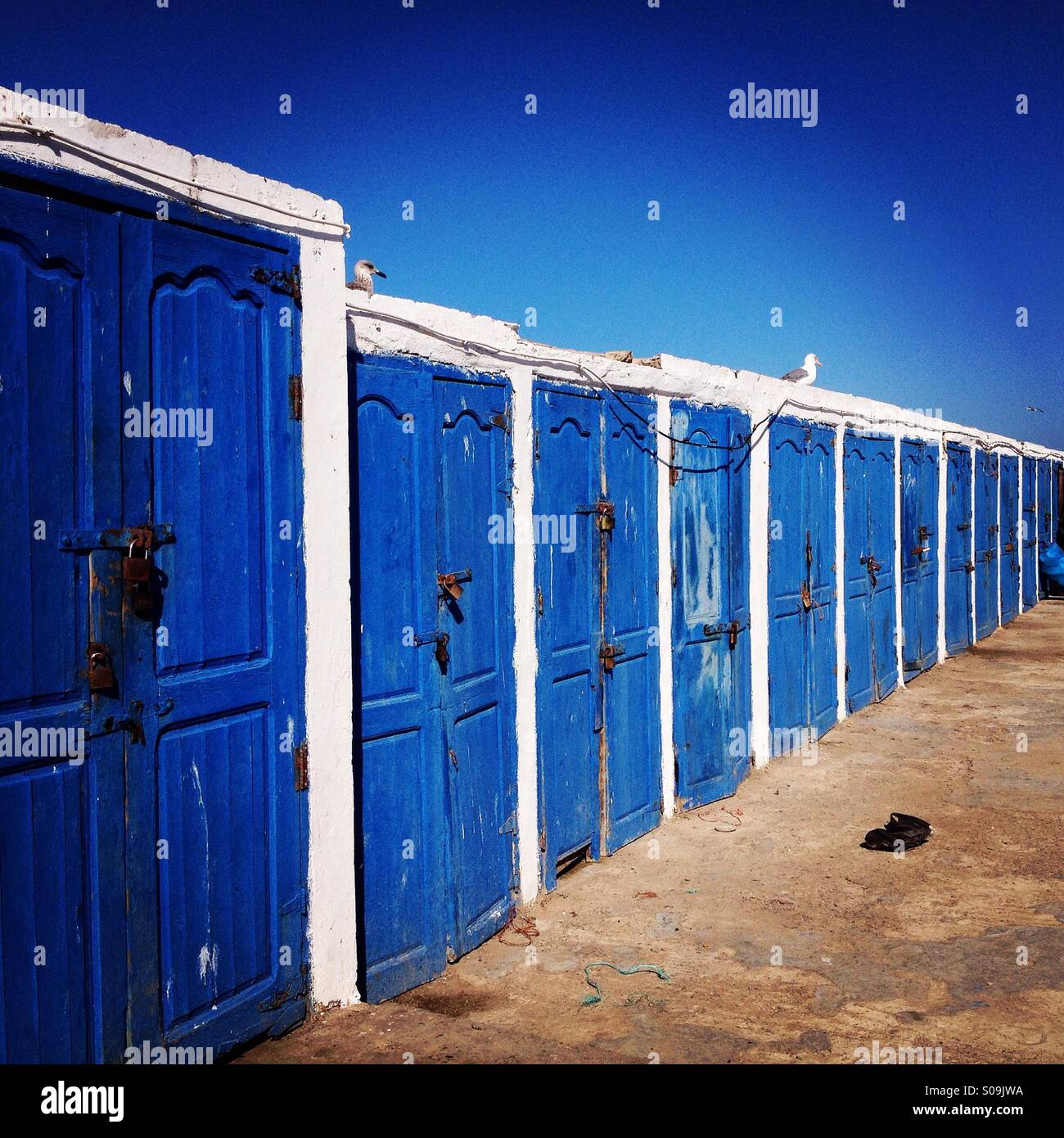 Blue doors in the port and fishing harbour of Essaouira, a UNESCO world heritage town in Morocco. Stock Photo