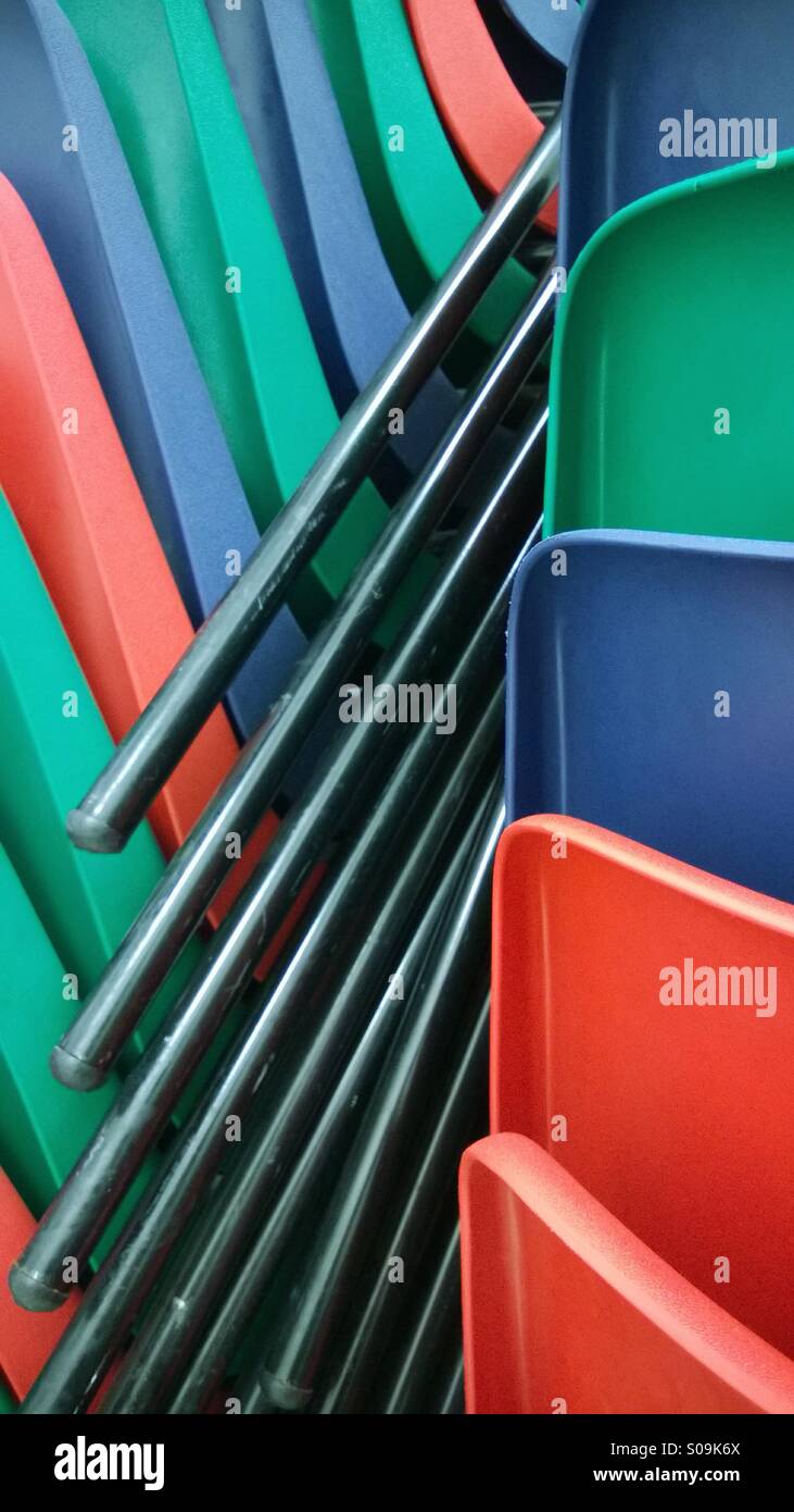 Colourful plastic chairs stacked Stock Photo Alamy