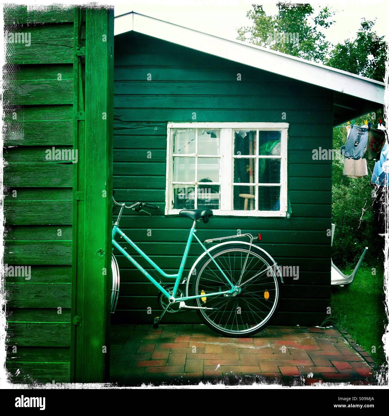 Bicycle in front of green hut. - Smartphone Captured Stock Image