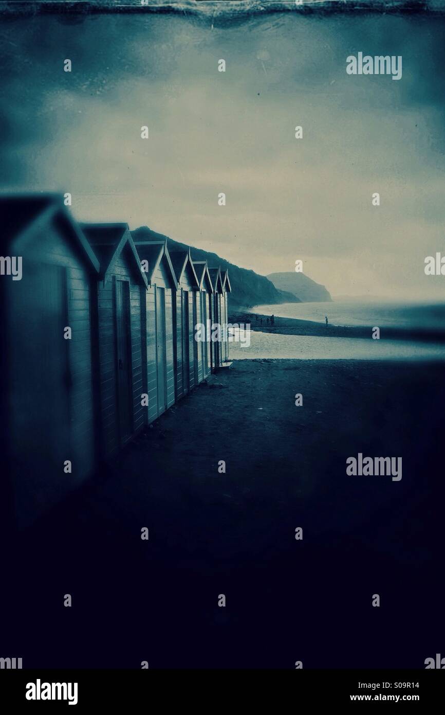 Beach huts on a wet and rainy Charmouth beach Devon England UK - Smartphone Captured Stock Image