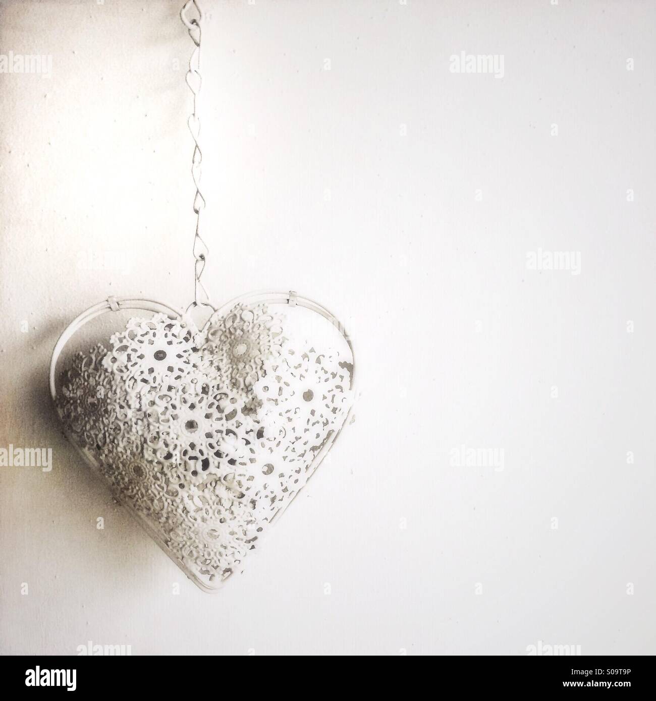 Heart hanging on a chain Stock Photo