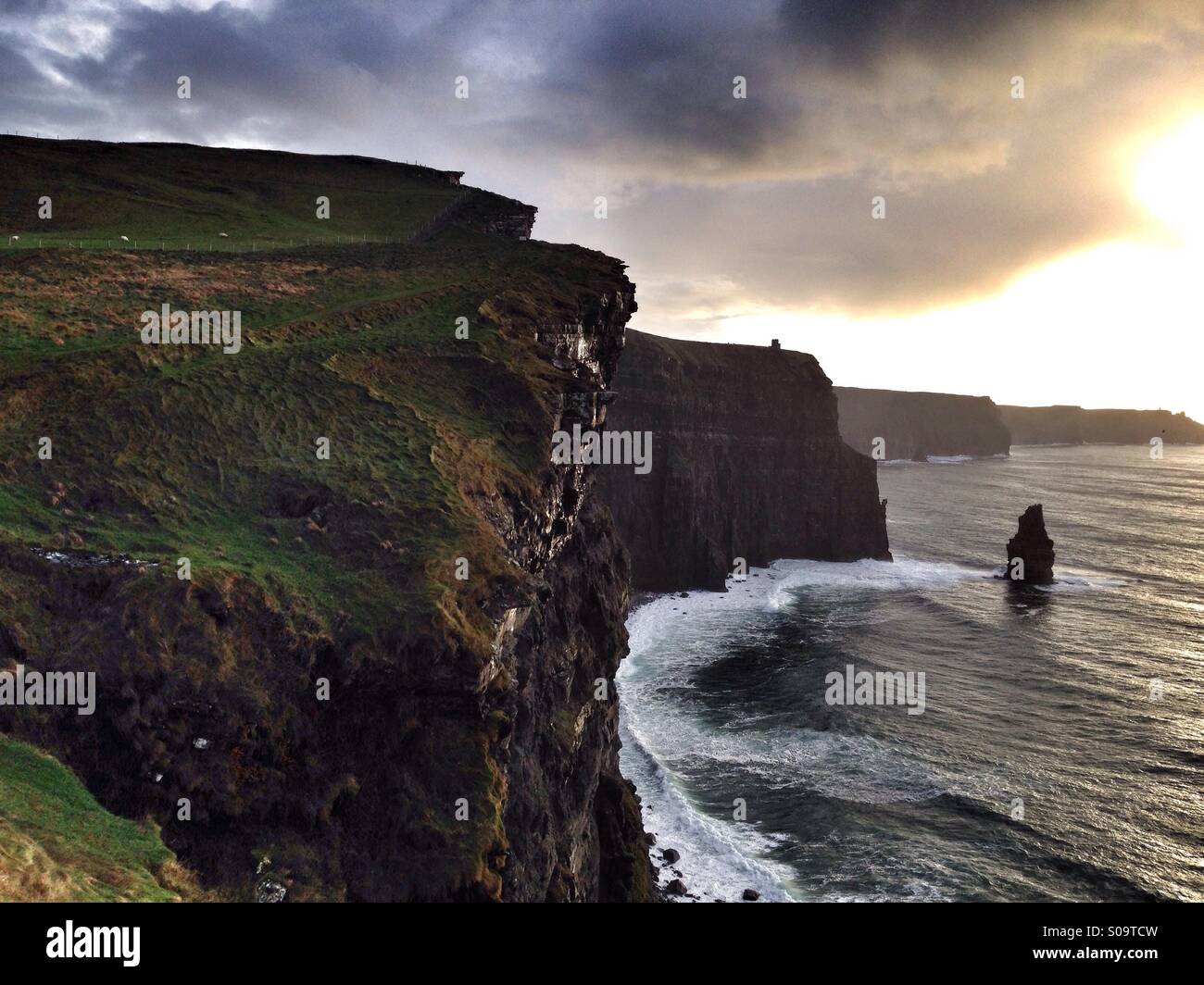 Irish landscape: the Cliffs of Moher under a cloudy sky at sunset - Smartphone Captured Stock Image