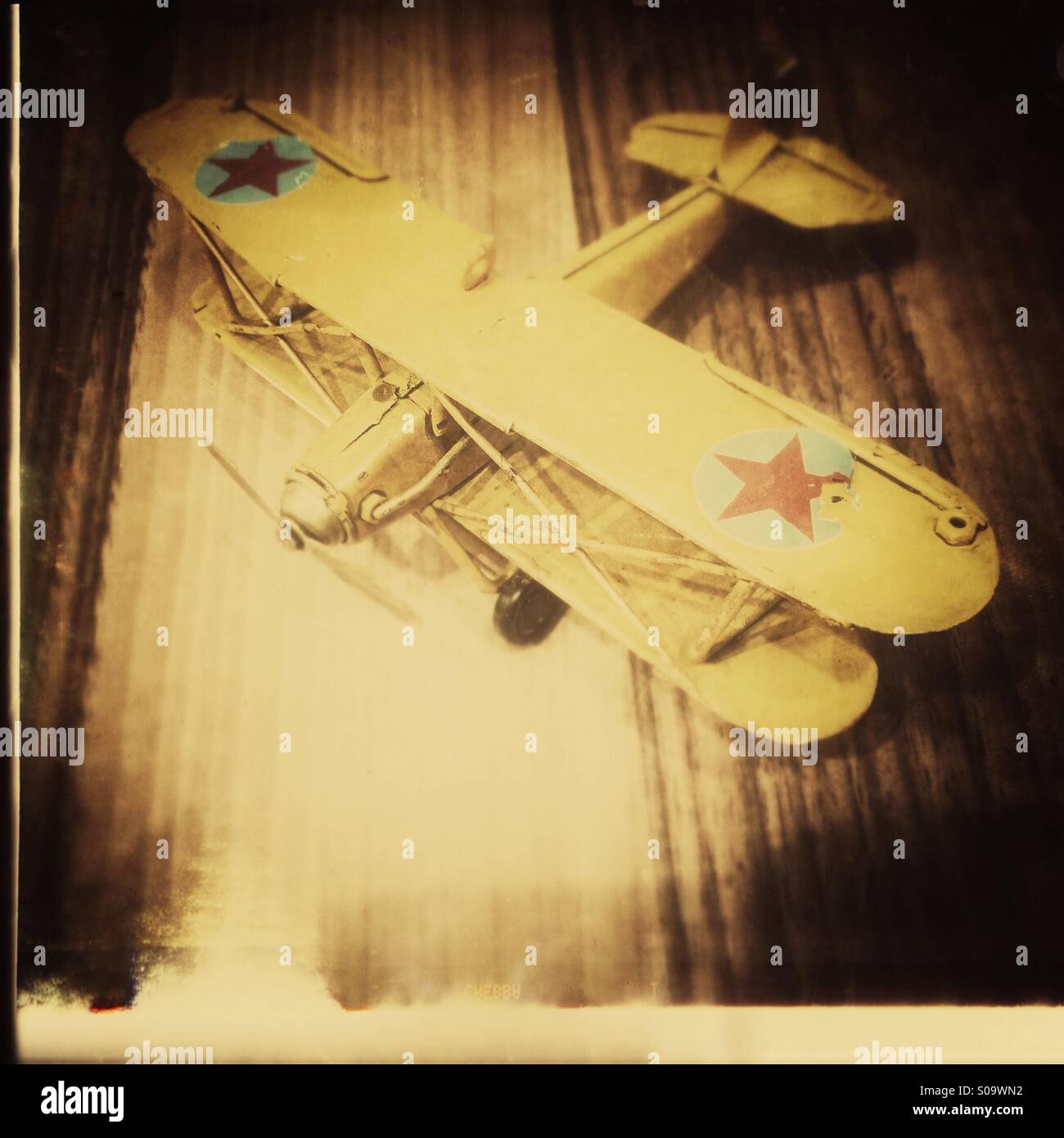 Yellow old metal toy plane Stock Photo