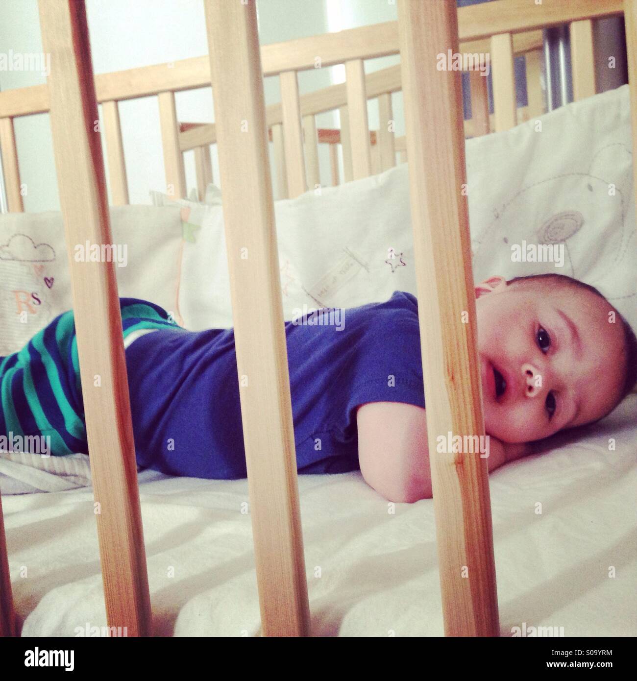 Toddler in cot Stock Photo Alamy