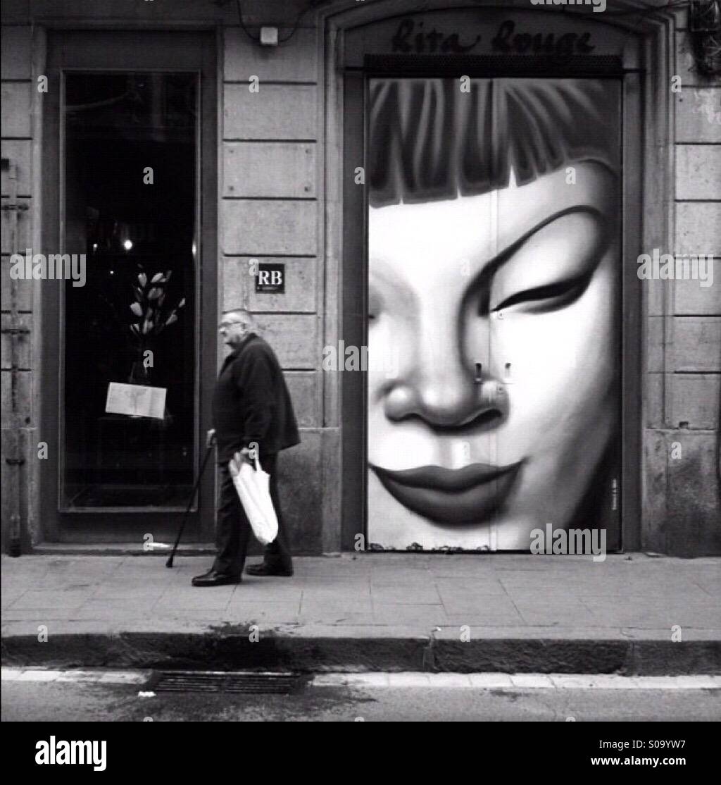 Man walking past street art - Smartphone Captured Stock Image