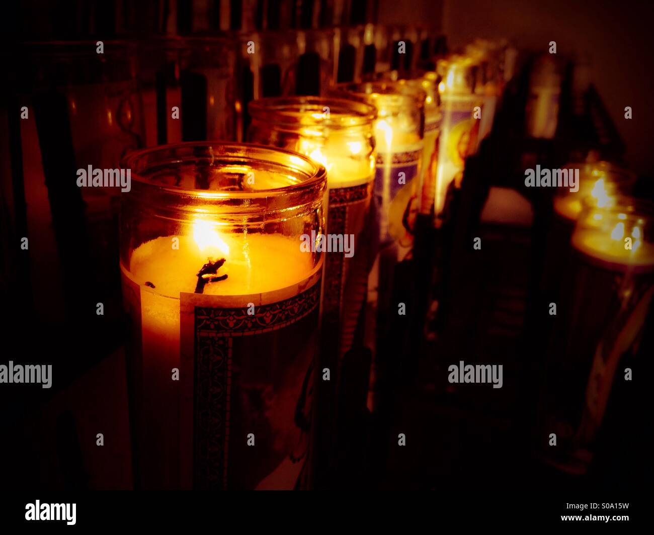 Candles burn at a mission. - Smartphone Captured Stock Image