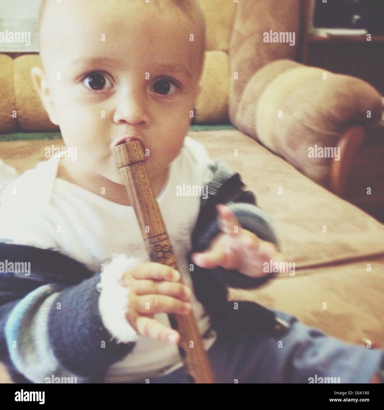 A small child sing a song at musical instrument Stock Photo