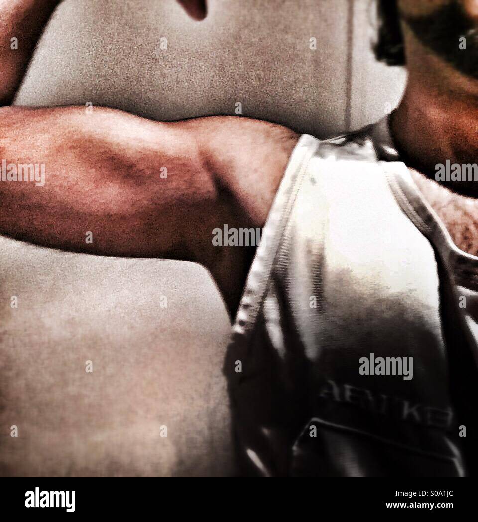 A guy flexing his muscles. - Smartphone Captured Stock Image