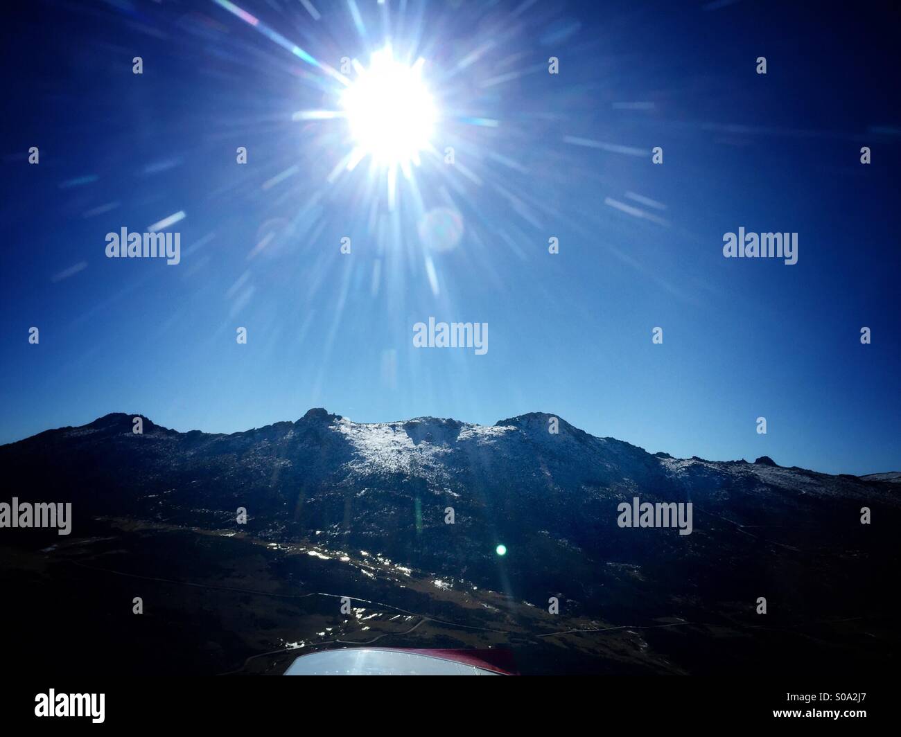 Sun and mountain photographed from plane Stock Photo - Alamy