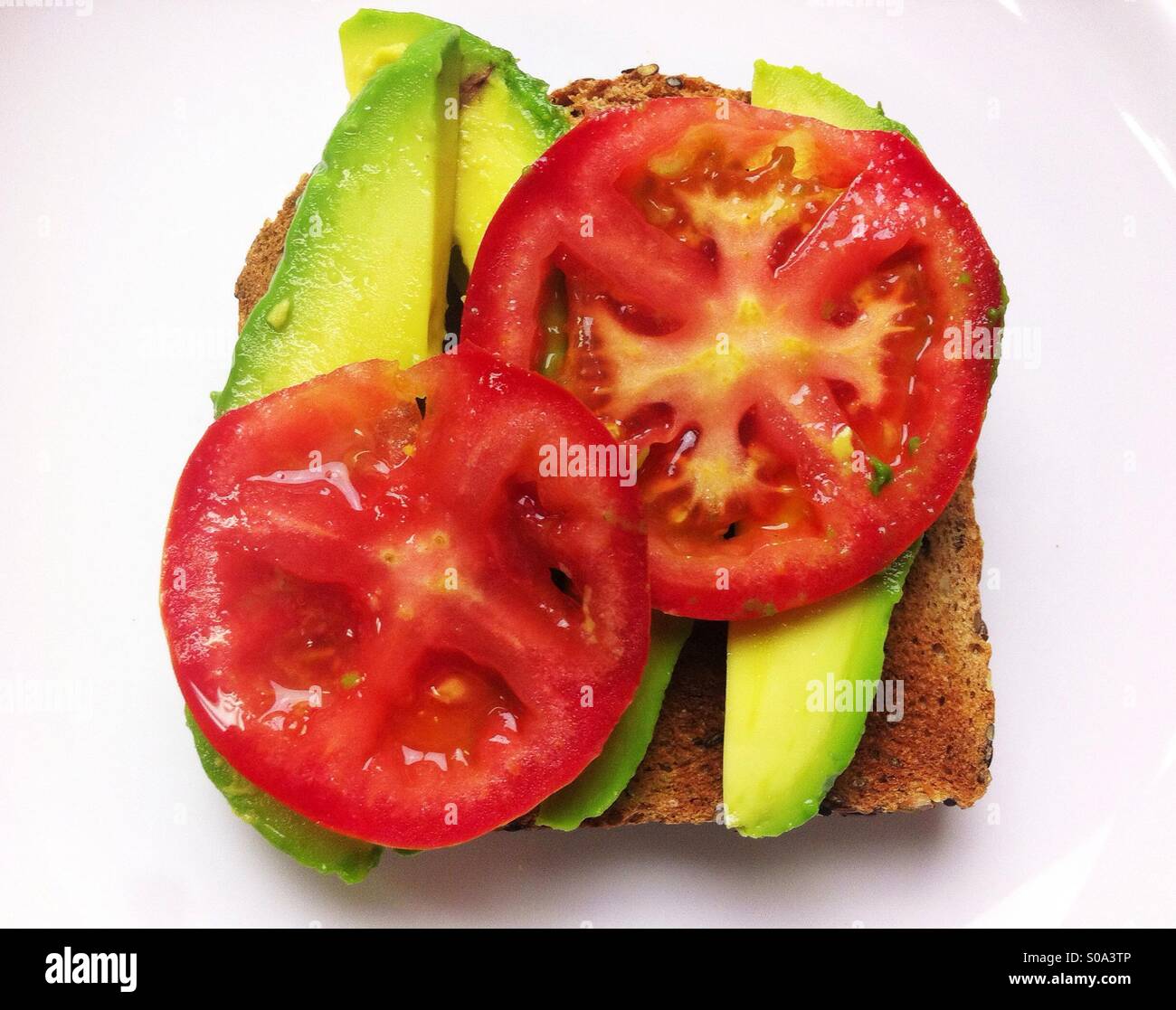 Open vegetable sandwich on whole wheat bread with avocado and tomato - Smartphone Captured Stock Image