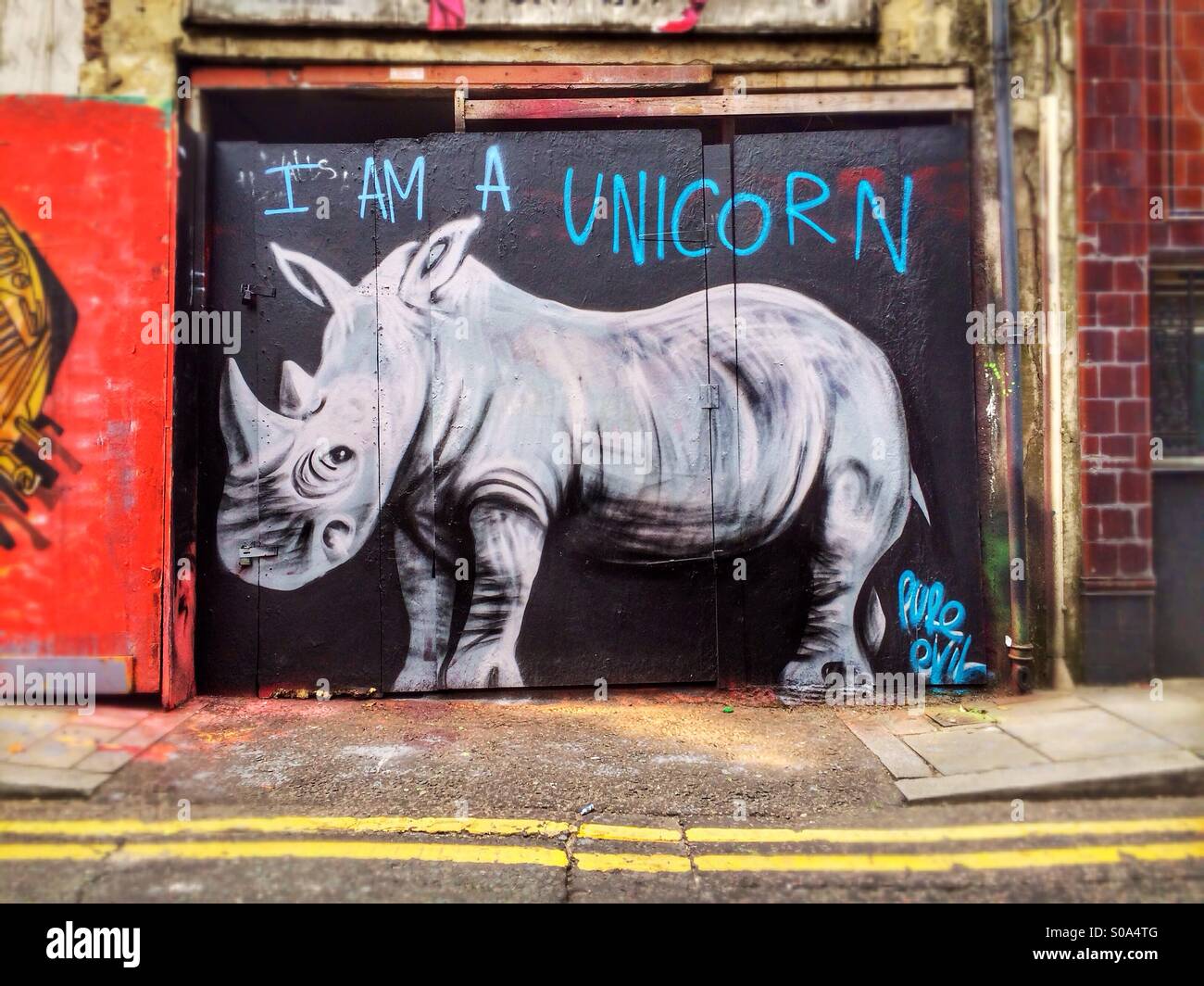 Graffiti By Street Artist Pure Evil Depicting A Rhino With The Slogan Stock Photo Alamy