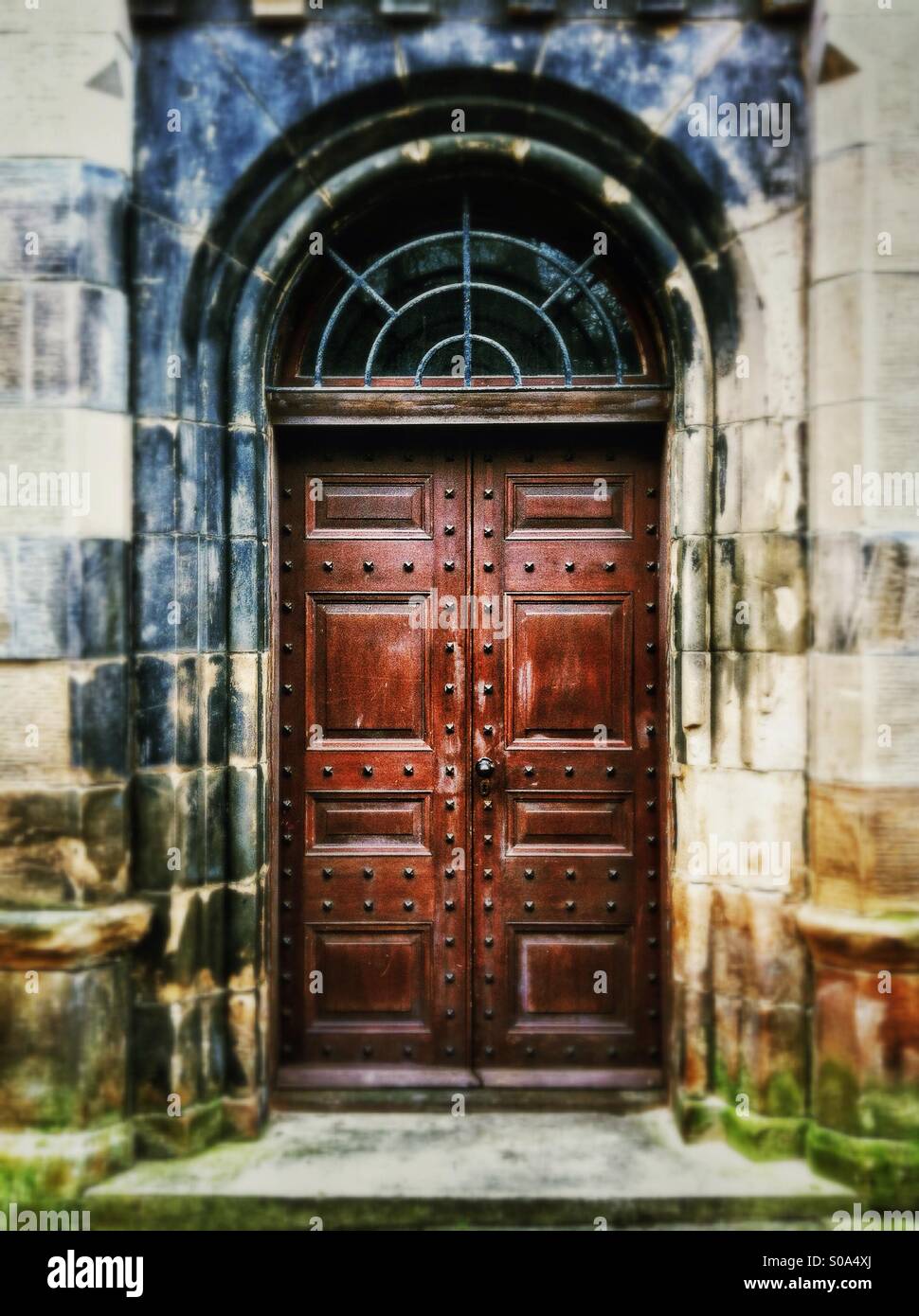 Heavy old wooden door in Victorian building. - Smartphone Captured Stock Image