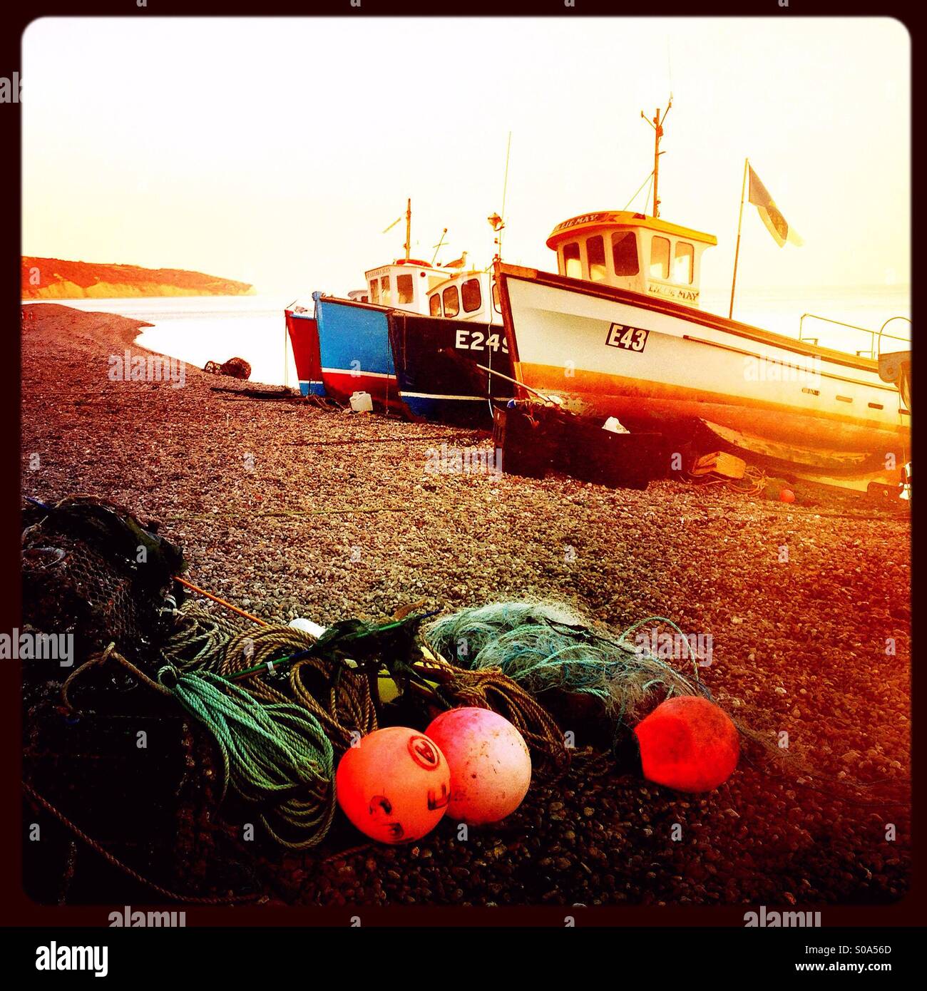 Fishing boats beached in the port of Beer, Devon, England Stock Photo