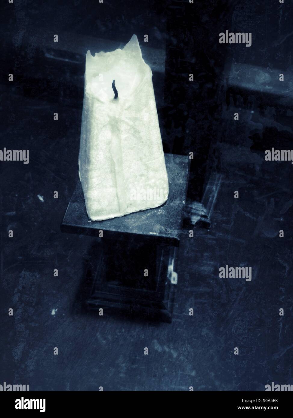 Triangle cubic candle on a wooden stand - Smartphone Captured Stock Image