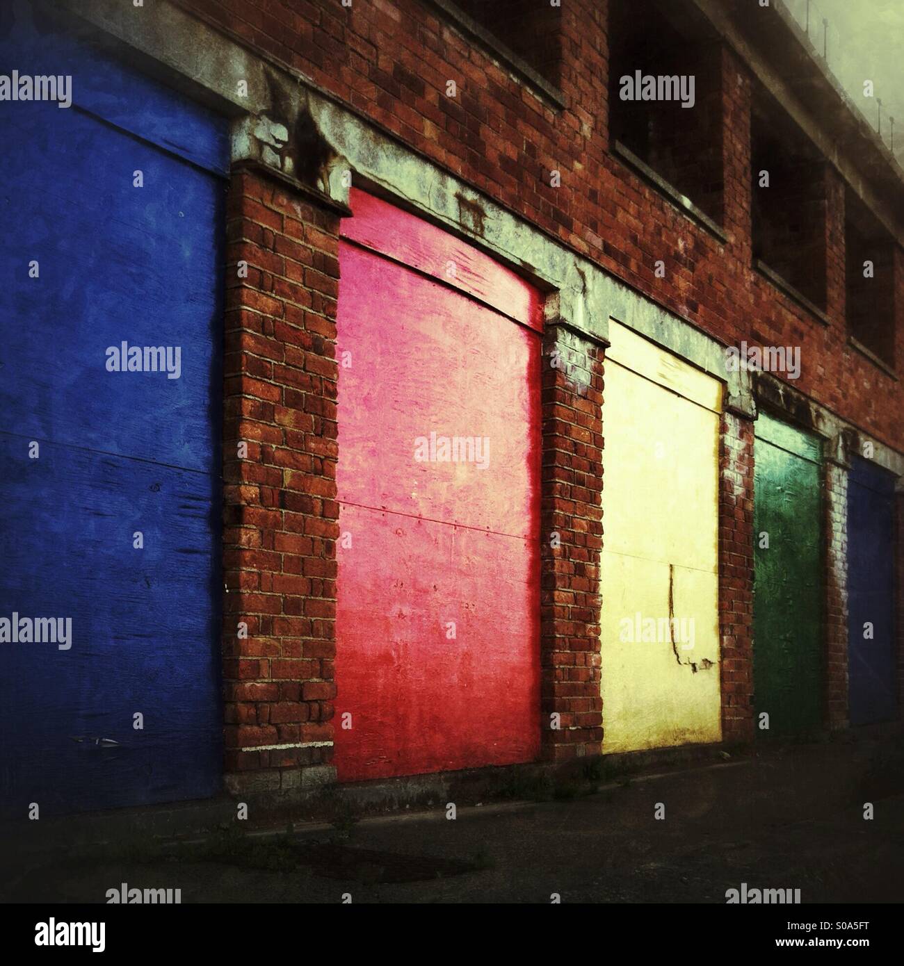 Colourful doors on storage units in brick building Stock Photo Alamy