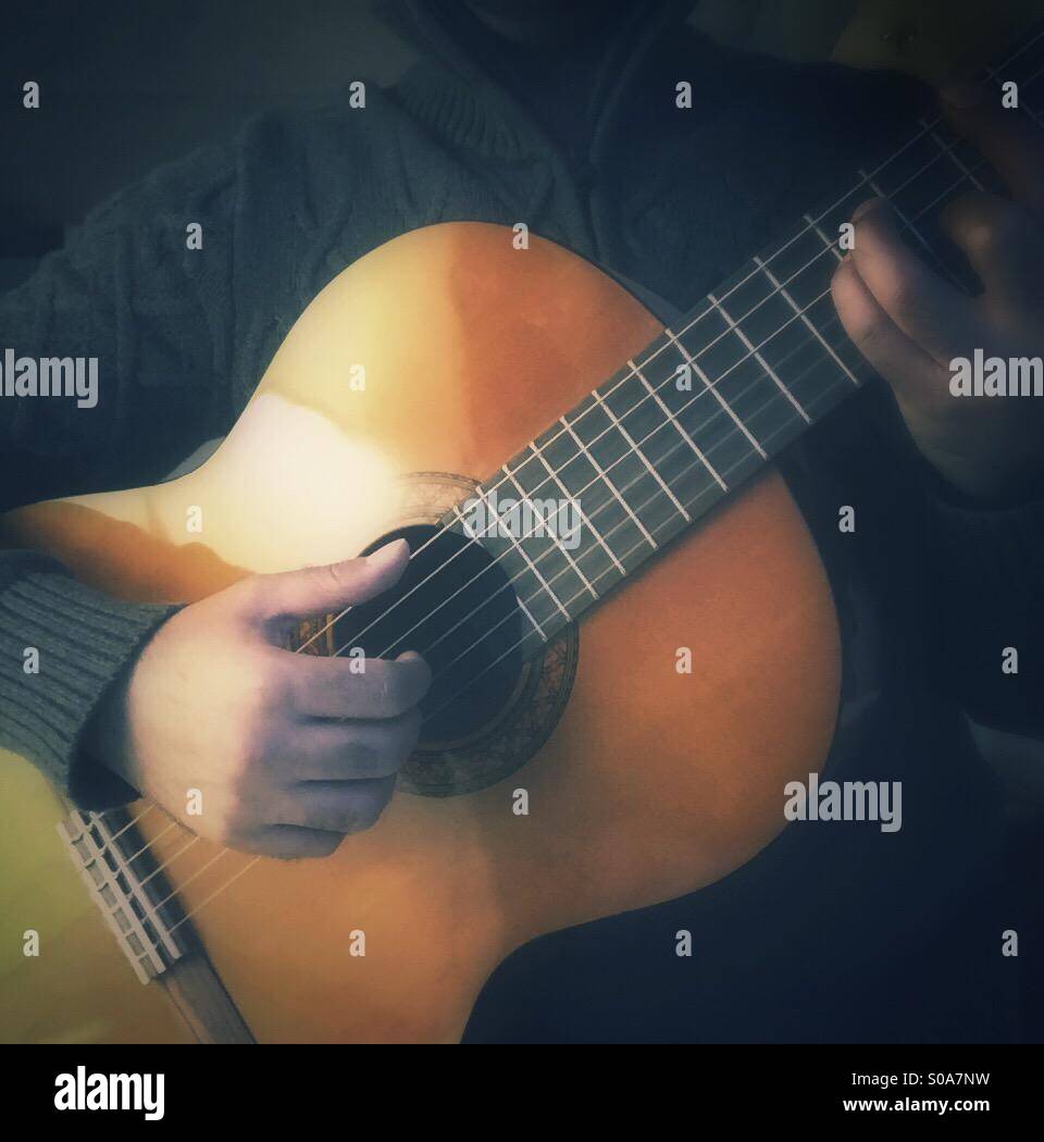 A guy playing classical guitar - Smartphone Captured Stock Image