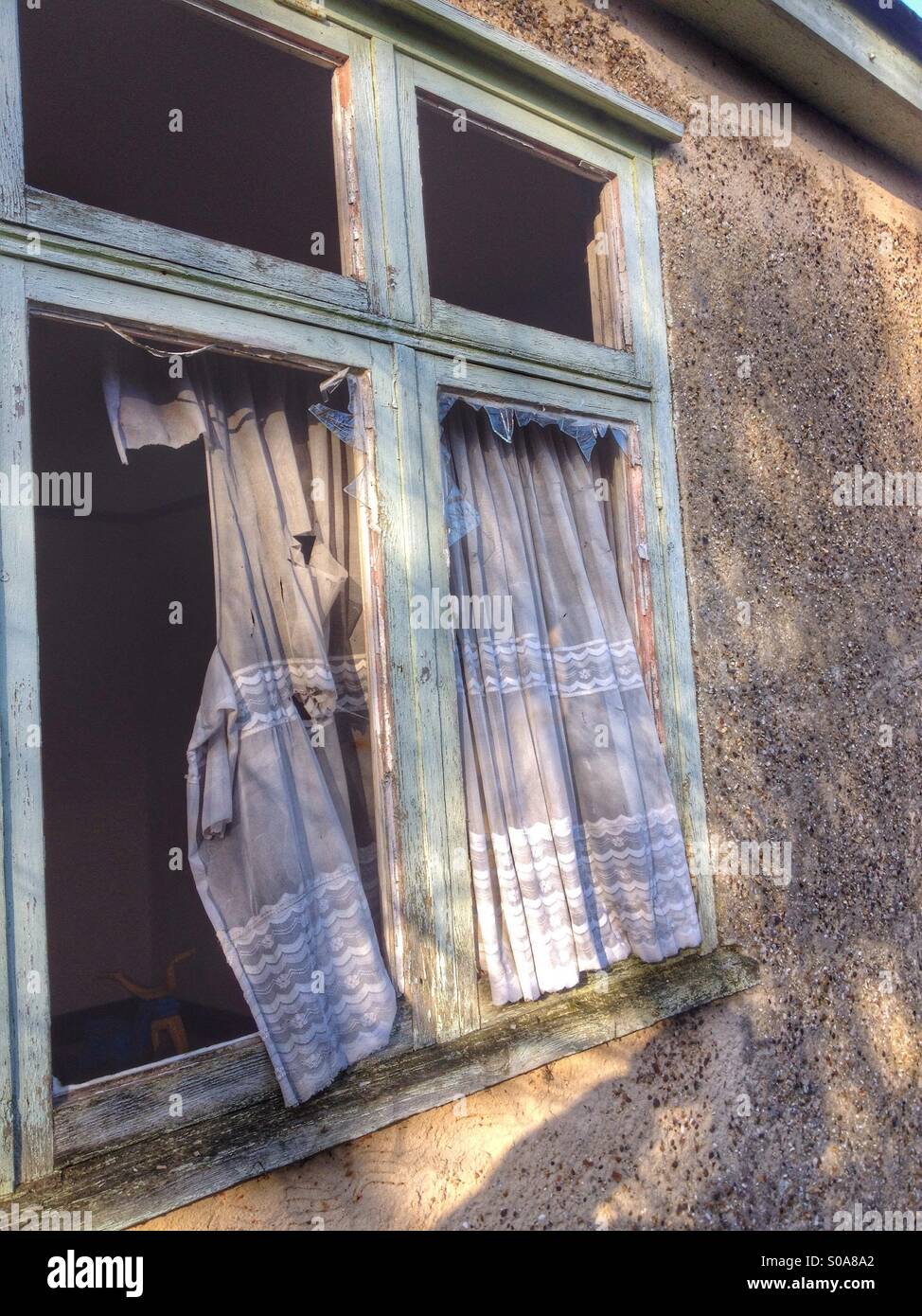 Unoccupied house with smashed windows - Smartphone Captured Stock Image