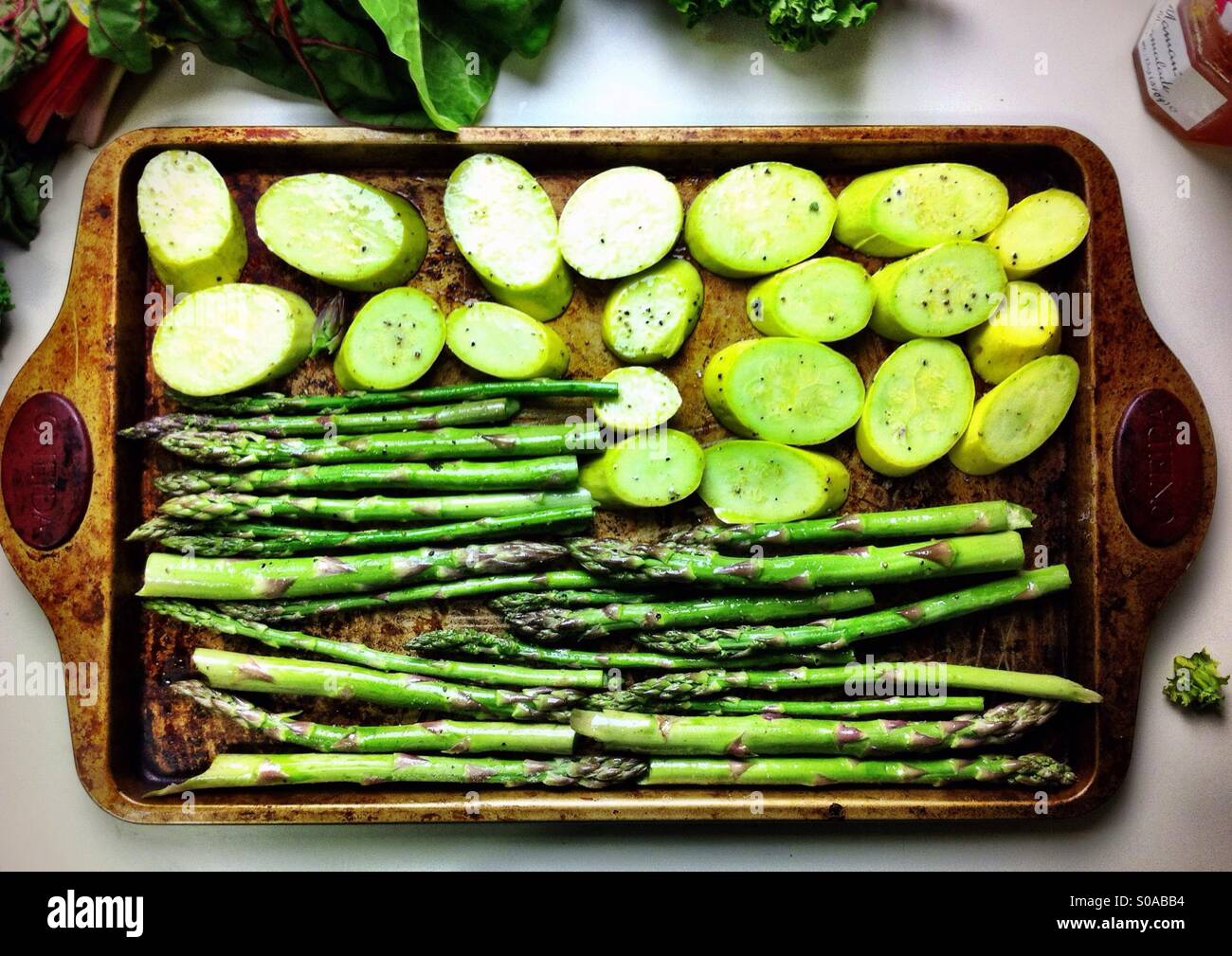 Vegetables on a baking sheet ready for roasting Stock Photo Alamy