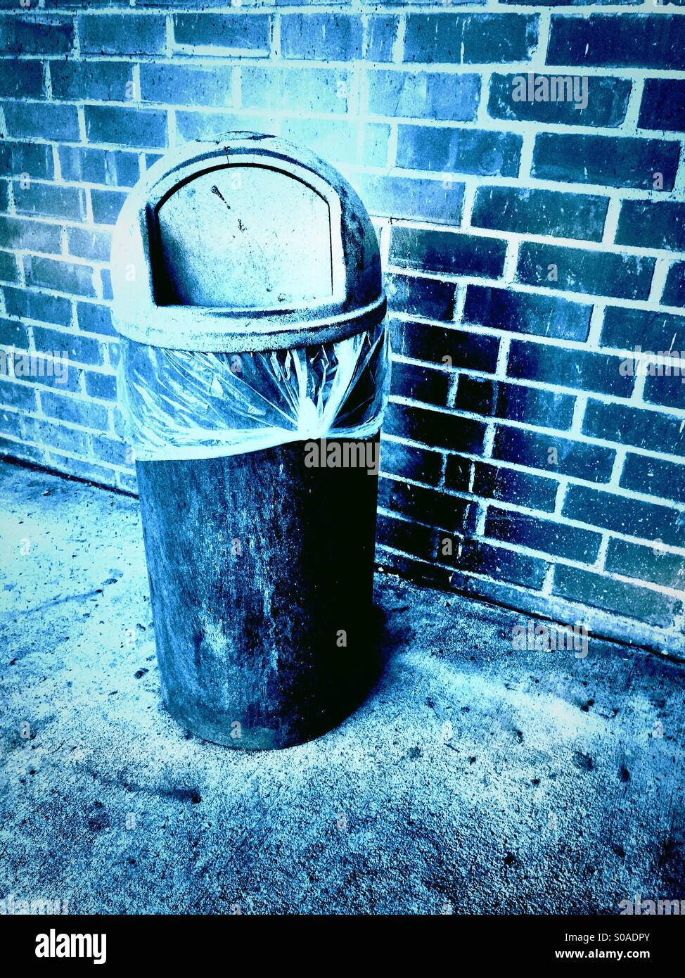 A trash can by a brick wall Stock Photo Alamy