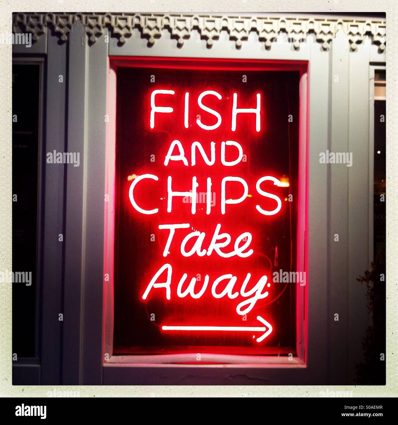 Neon fish and chips take away sign - Smartphone Captured Stock Image