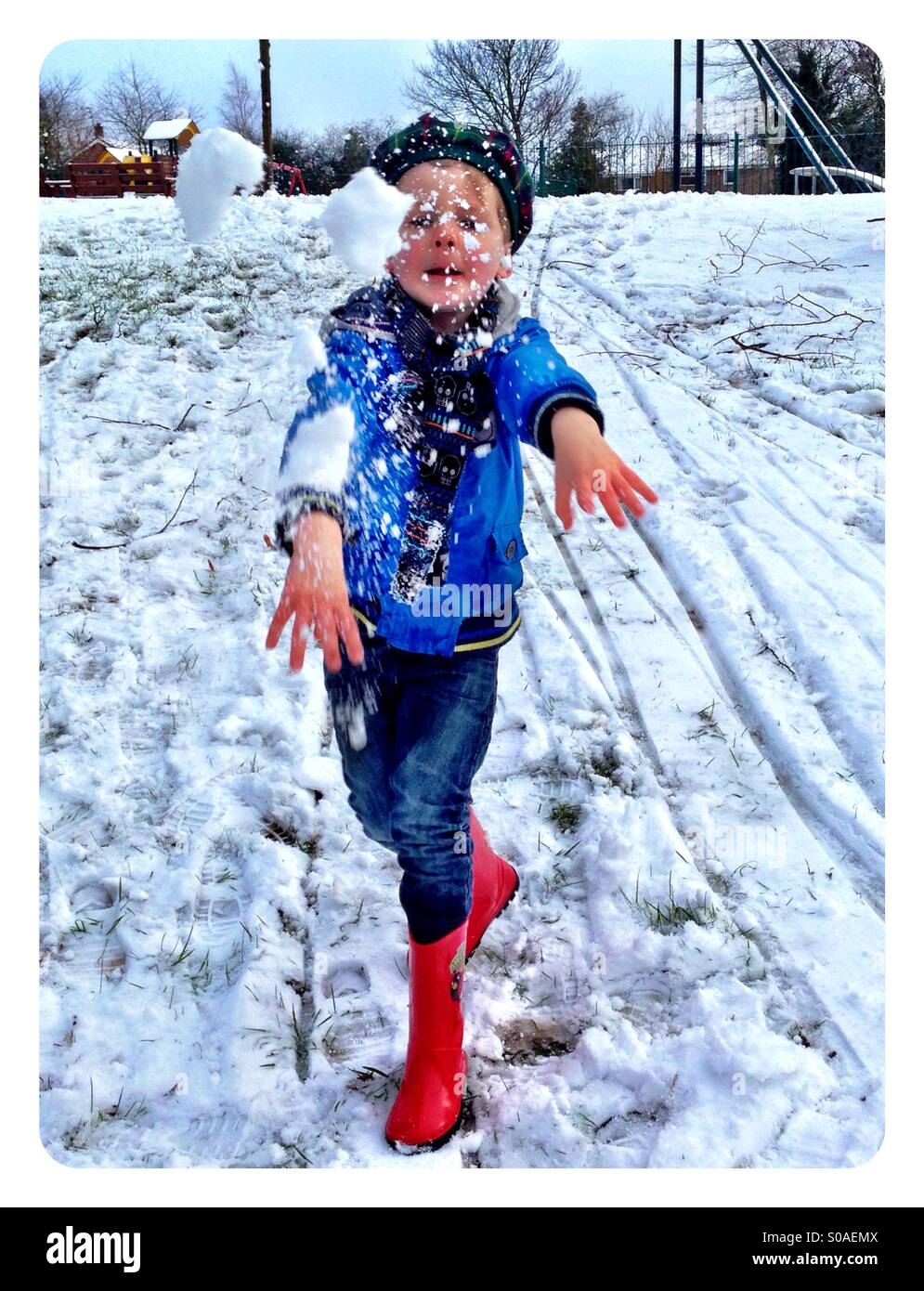 Snowball fight. Boy playing in the snow. Stock Photo