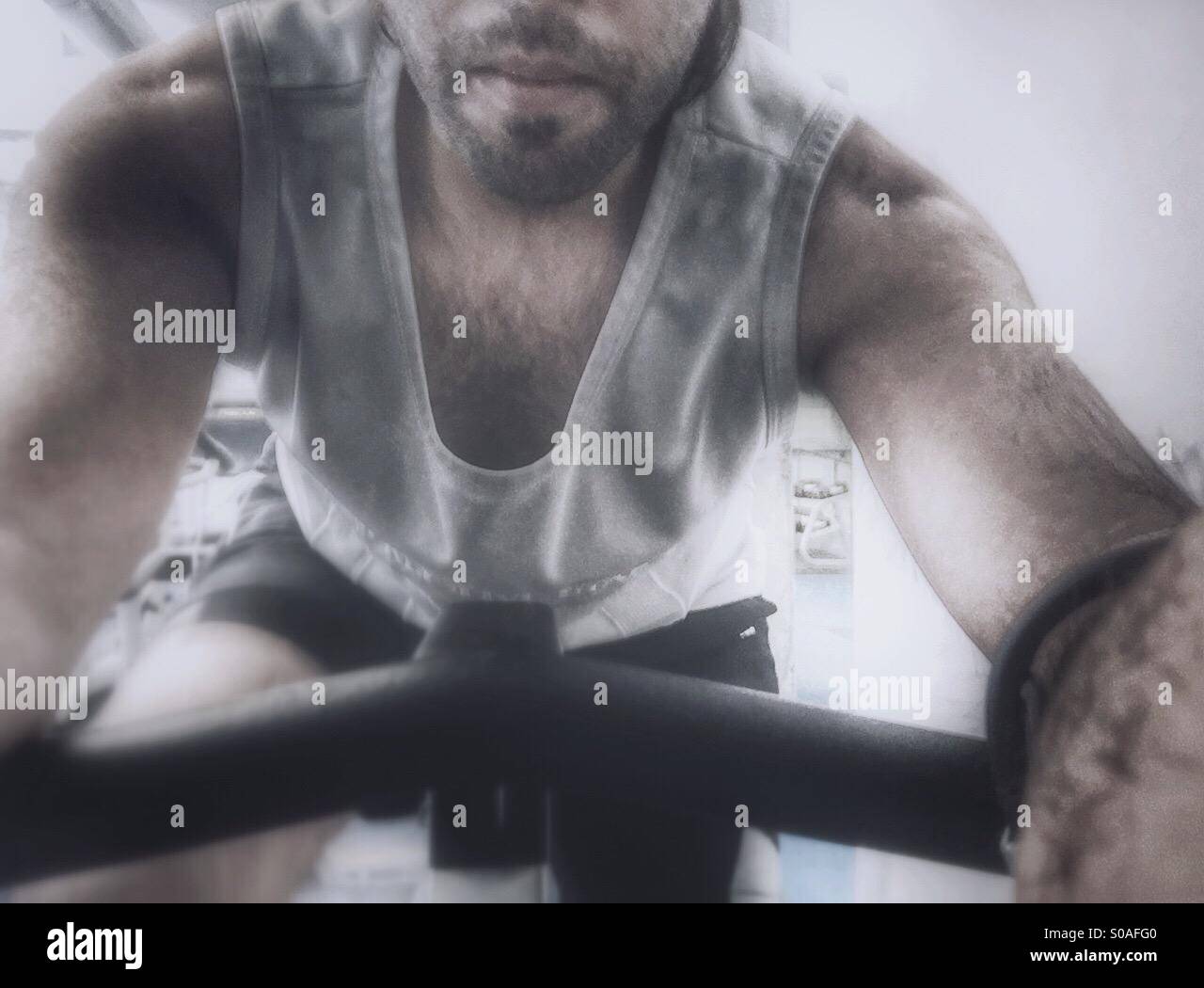A guy at the gym on a stationary bike - Smartphone Captured Stock Image