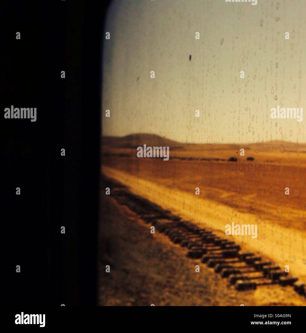 View of desert landscape through train window - Smartphone Captured Stock Image