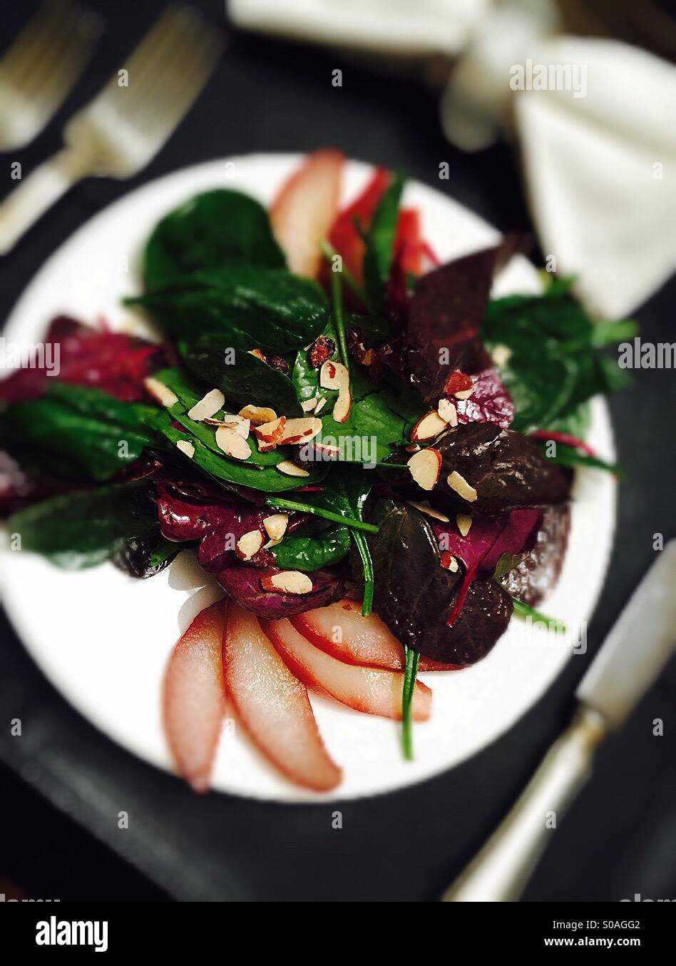 Spinach and pear salad at place setting - Smartphone Captured Stock Image