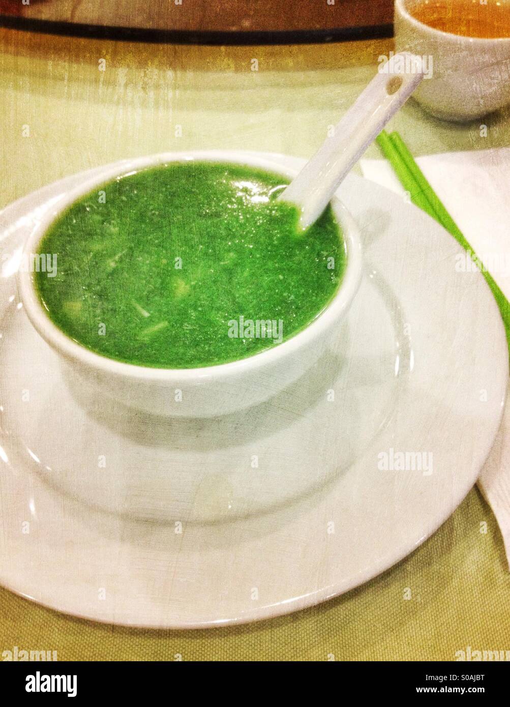 Bowl of green spinach soup at a Chinese restaurant - Smartphone Captured Stock Image