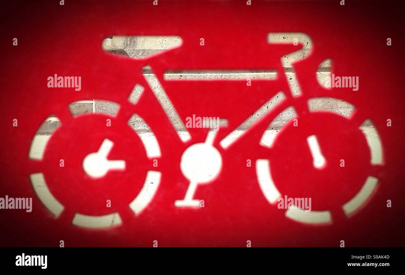 Sidewalk seen through the cutout of a bicycle stand. - Smartphone Captured Stock Image