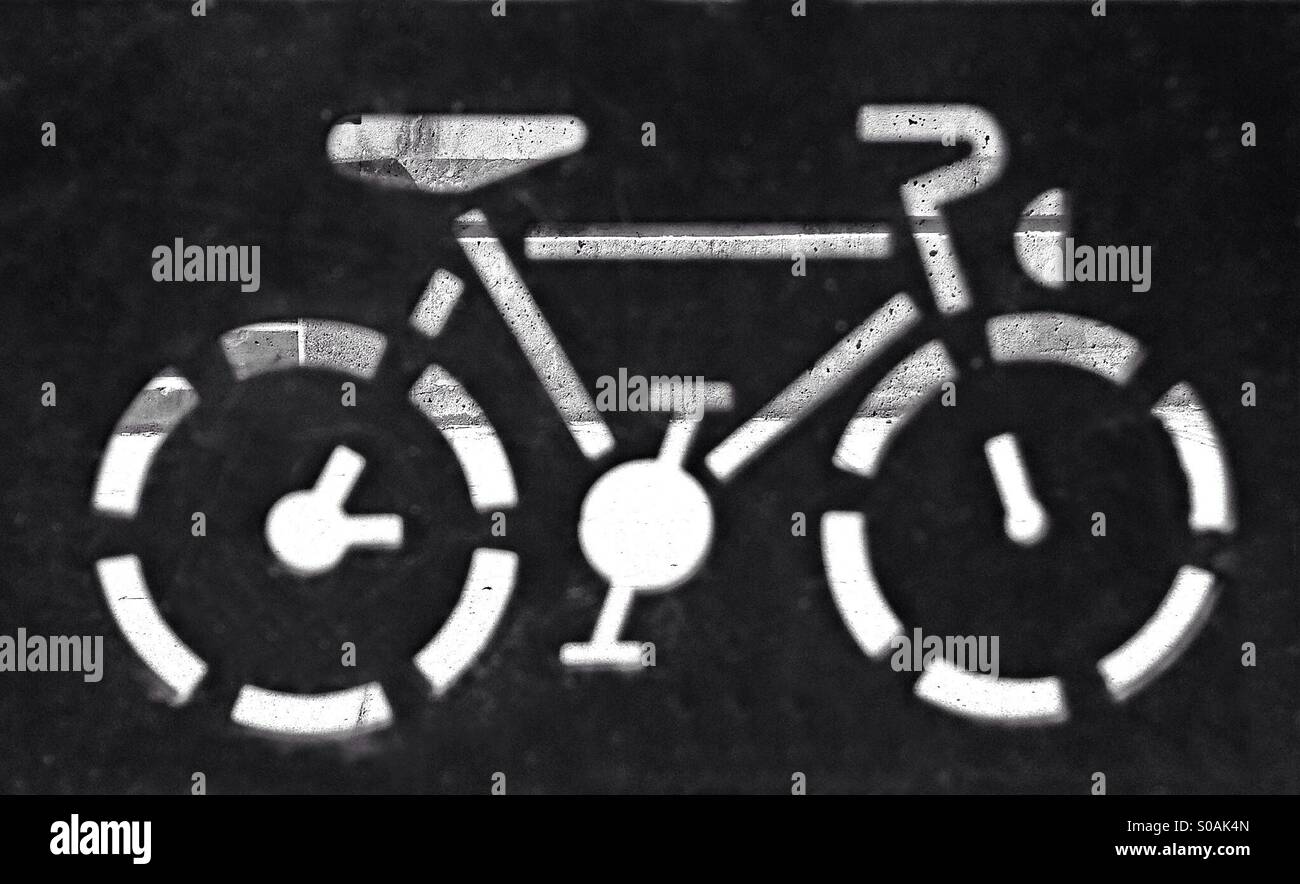 Sidewalk viewed through the cutout of a bicycle stand. - Smartphone Captured Stock Image