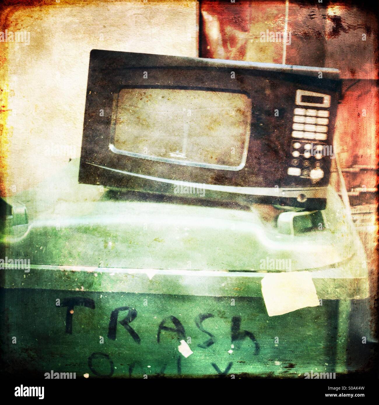 Old microwave oven sitting on top of a trash can Stock Photo Alamy