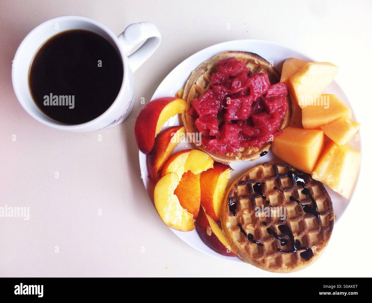 Breakfast of waffles, fruits and black coffee - Smartphone Captured Stock Image
